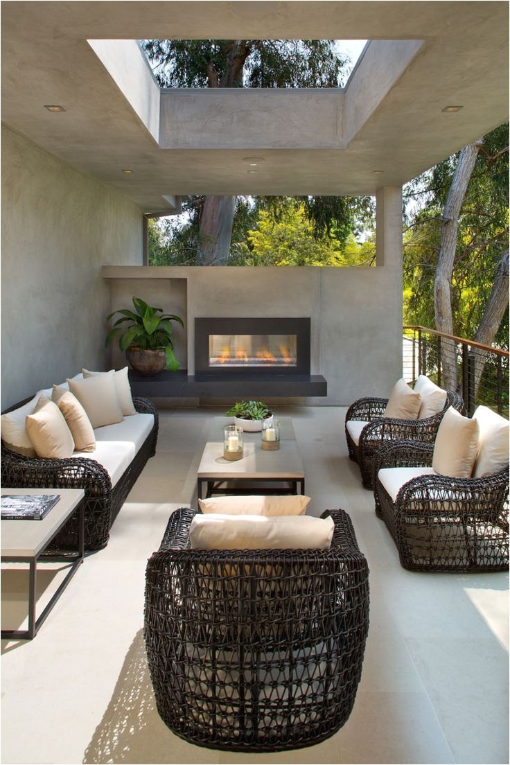 a contemporary redesign for this mid century modern home in los angeles this partially covered outdoor lounge has a fireplace to enjoy when it gets cool