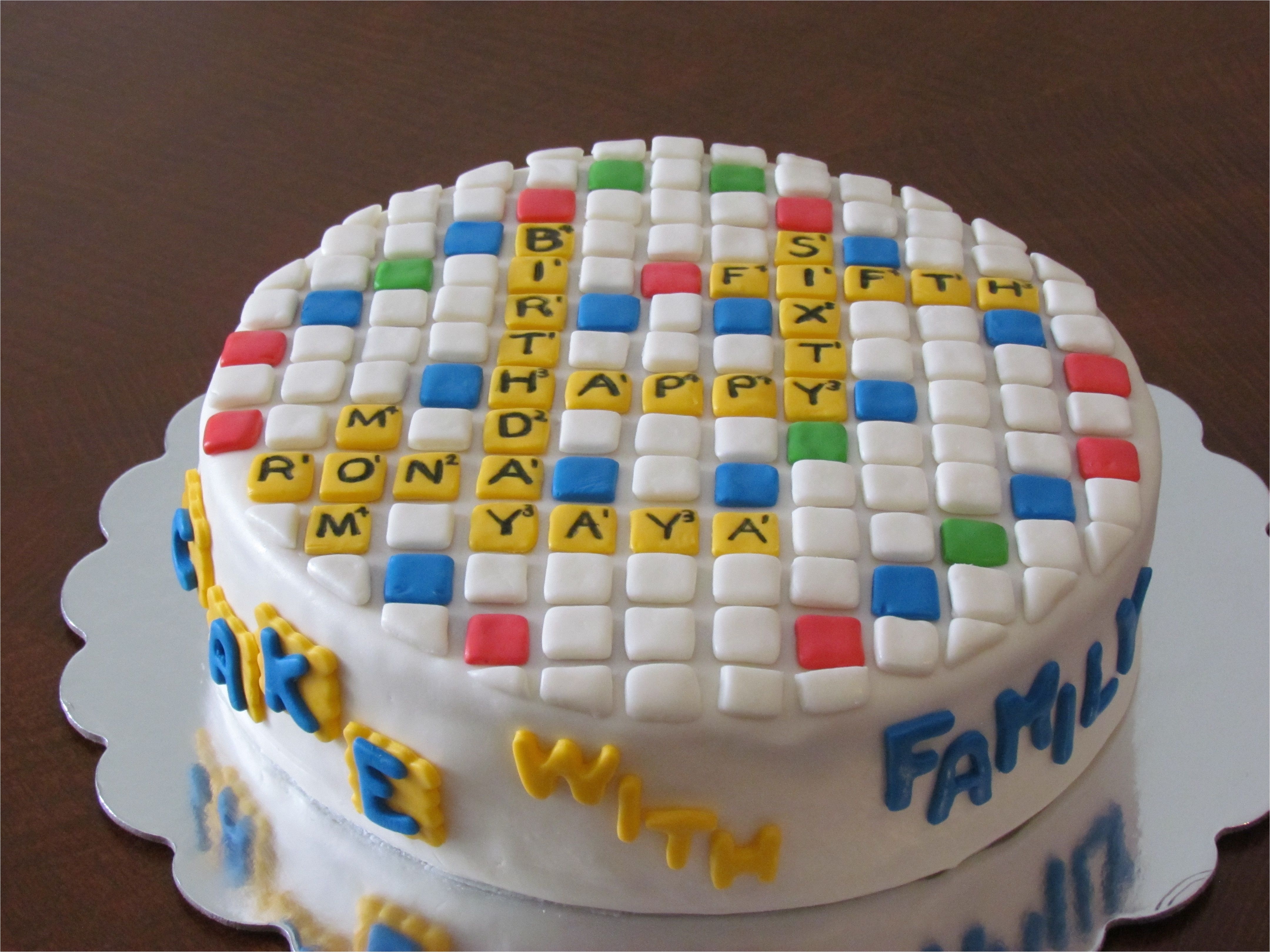 birthday cake i made this for my mom s 65th birthday she loves playing words with friends the front says cake with family all fondant decorations