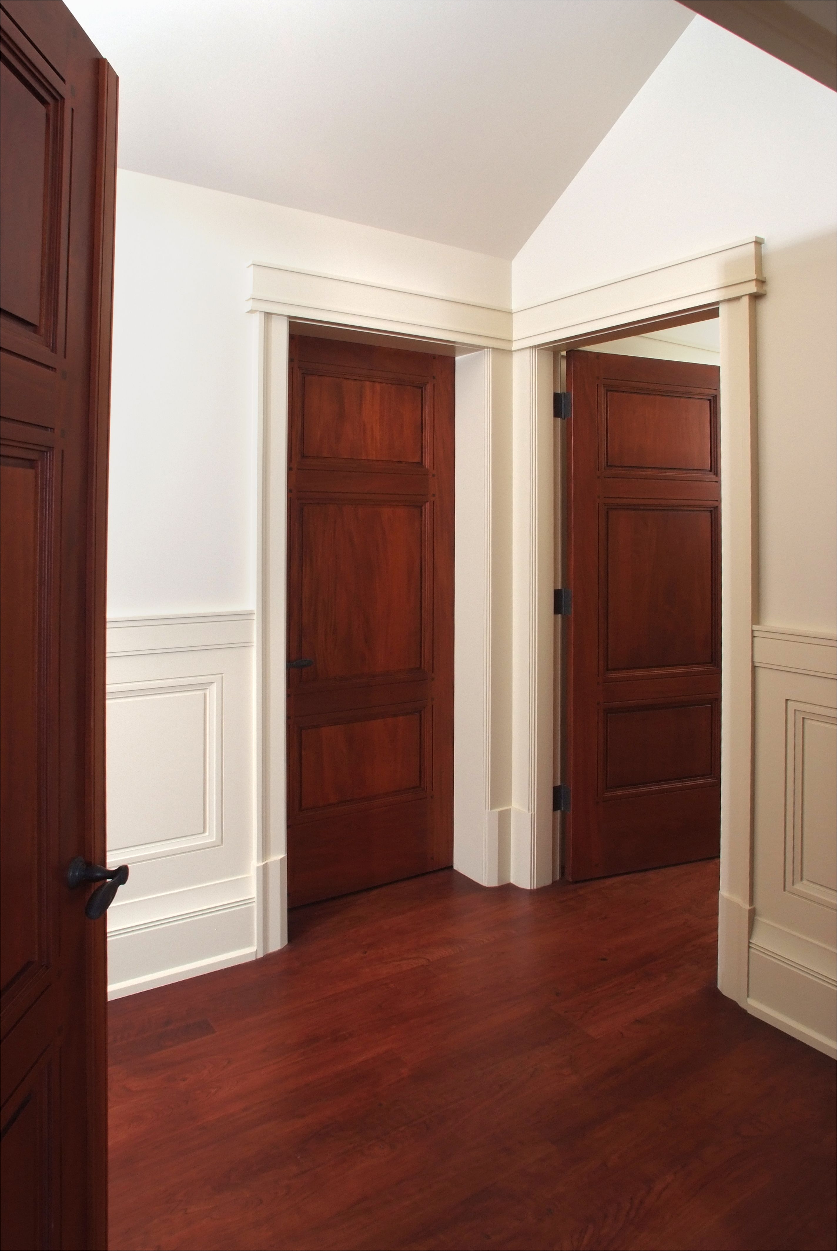 custom 3 panel mahogany interior door with craftsman style painted door casing and cherry hardwood floor