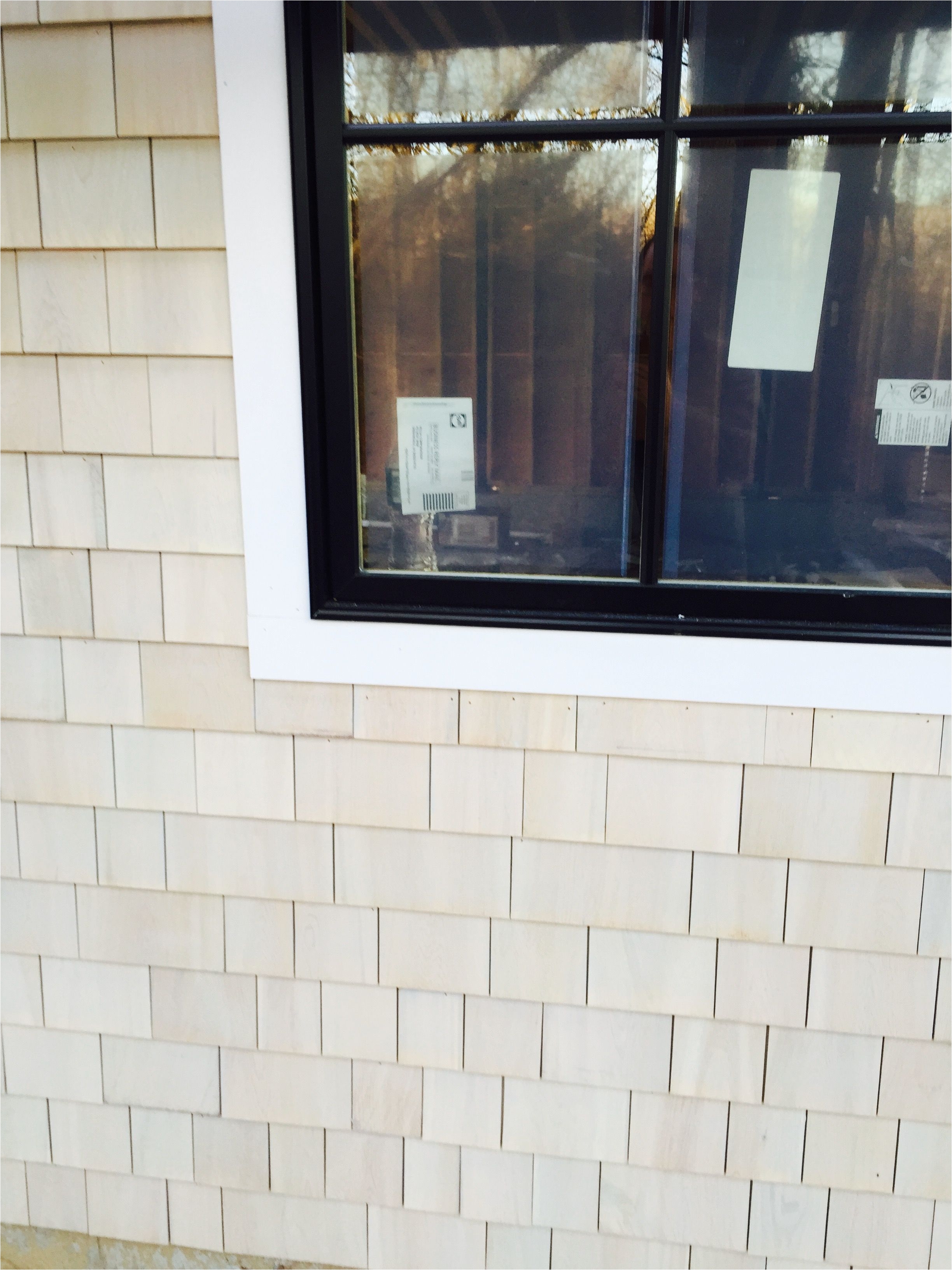 maibec white cedar shingle with bleaching agent next to pella casement window with black finish