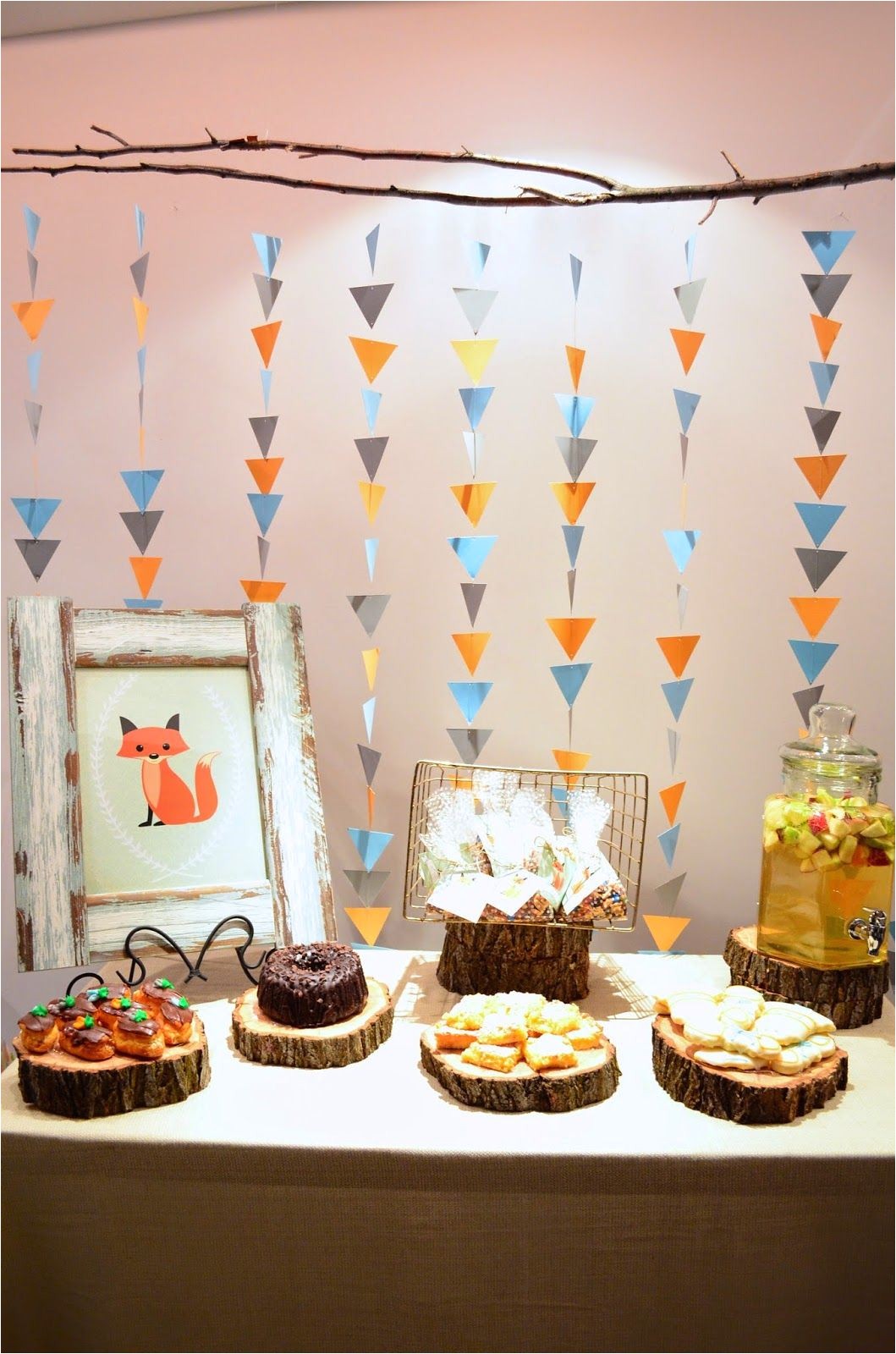 decorations love the simple triangle garland backdrop the wood slice platters and the framed artwork