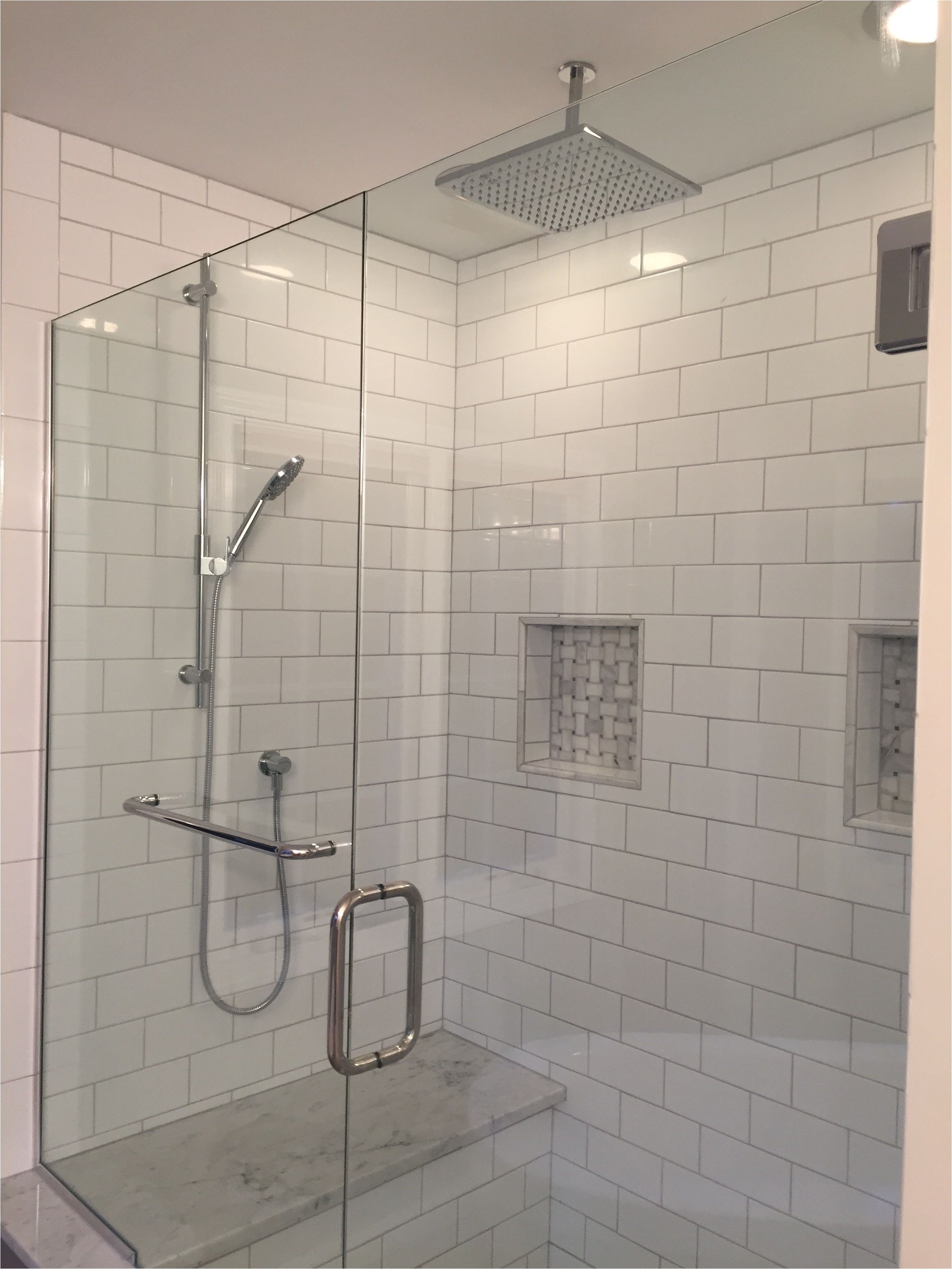 master bath shower makeover we choose white subway tile with whisper gray grout carrara marble for the bench seat and marble basket weave for the niches