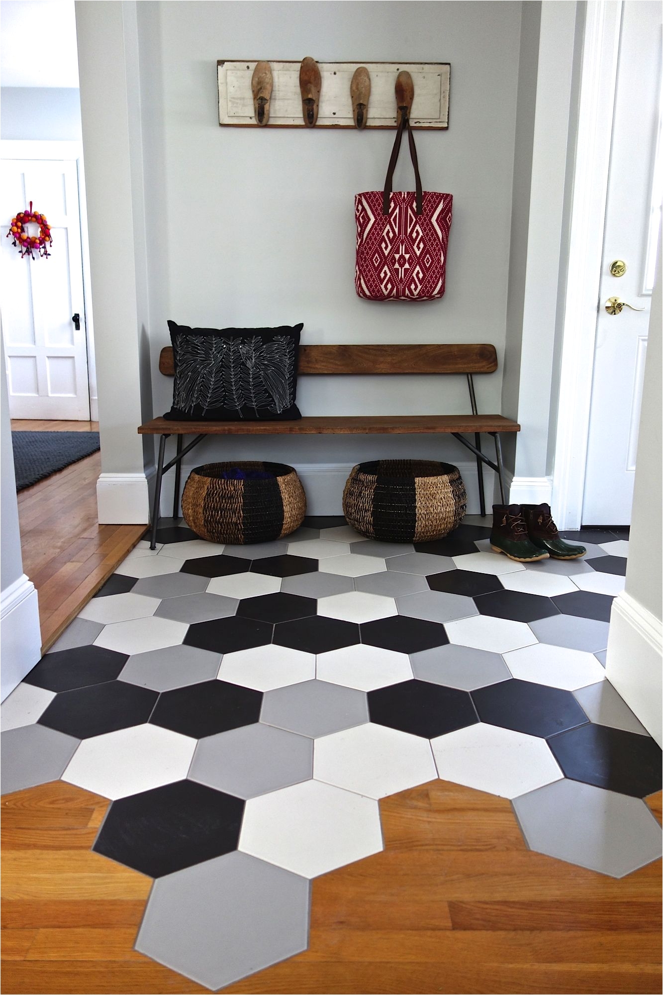 hex tile mudroom with transition to wood floor kitchen loving the ann sacks tiles and cb2 bench