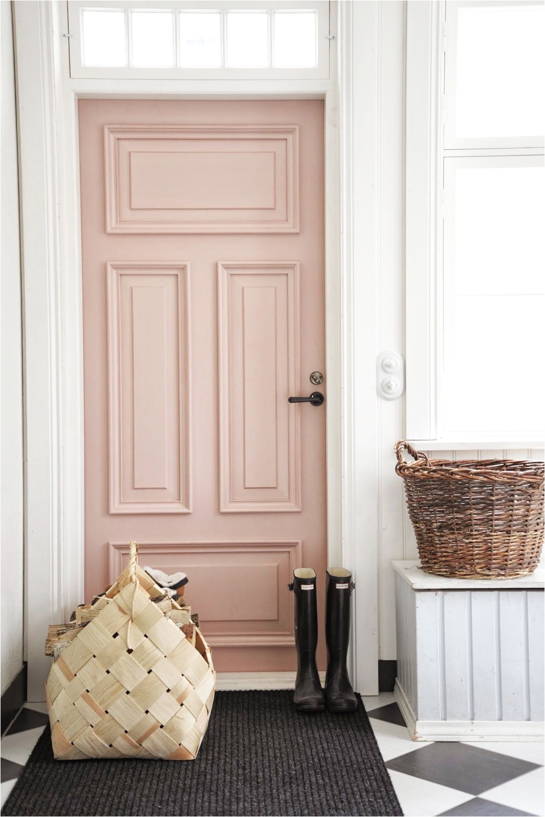 rose door inside home with tiled black and white floors