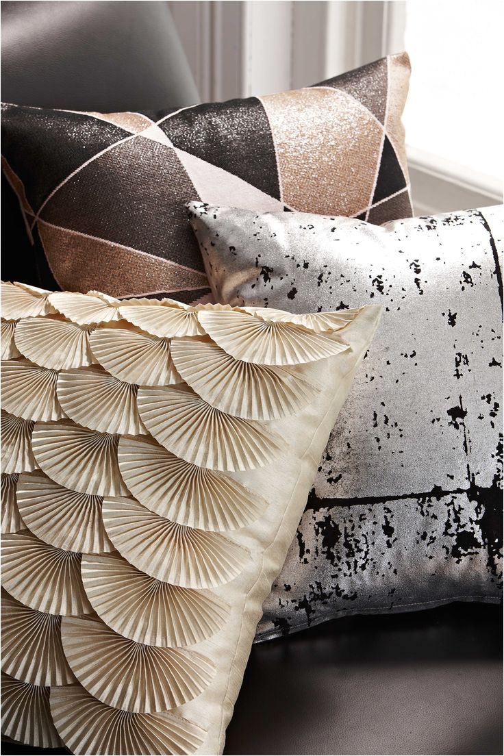 living room cushions on trend with the brass and metallic look of the coco cushion range from rapee uses abstract motifs geometric patterns and metallics