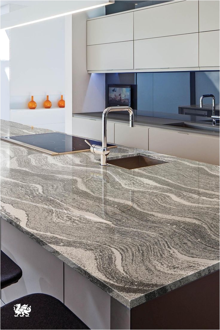 modernly sleek a roxwella island presents elegant serpentine swaths of gray dappled with white a cambria countertopskitchen