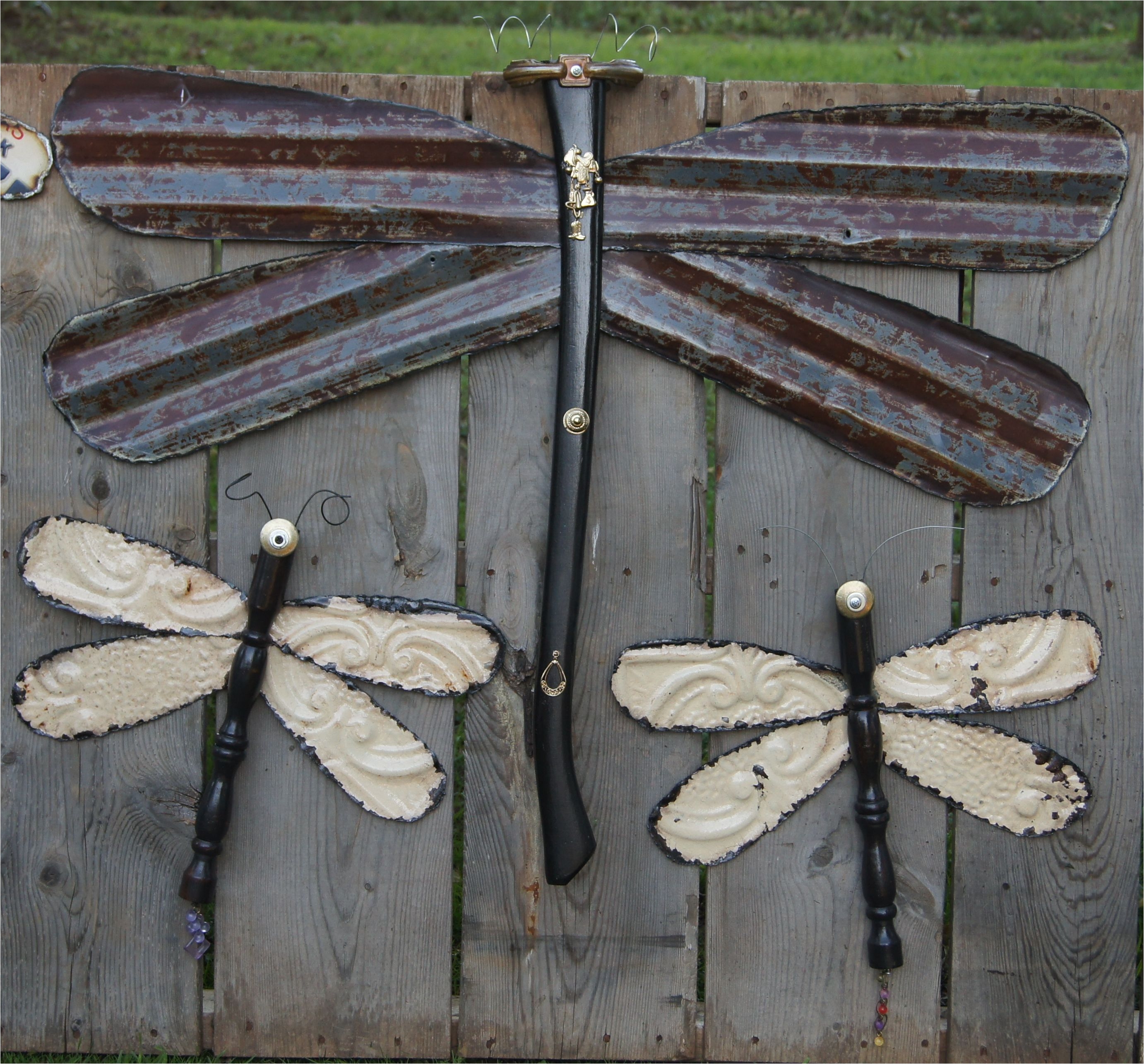 large dragonfly made from barn tin and ax handle small dragonflies made from chair leg