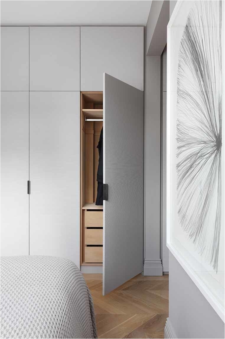 fabric clad wardrobe doors custom designed by interior id along with joseph giles leather pulls add texture to the master bedroom
