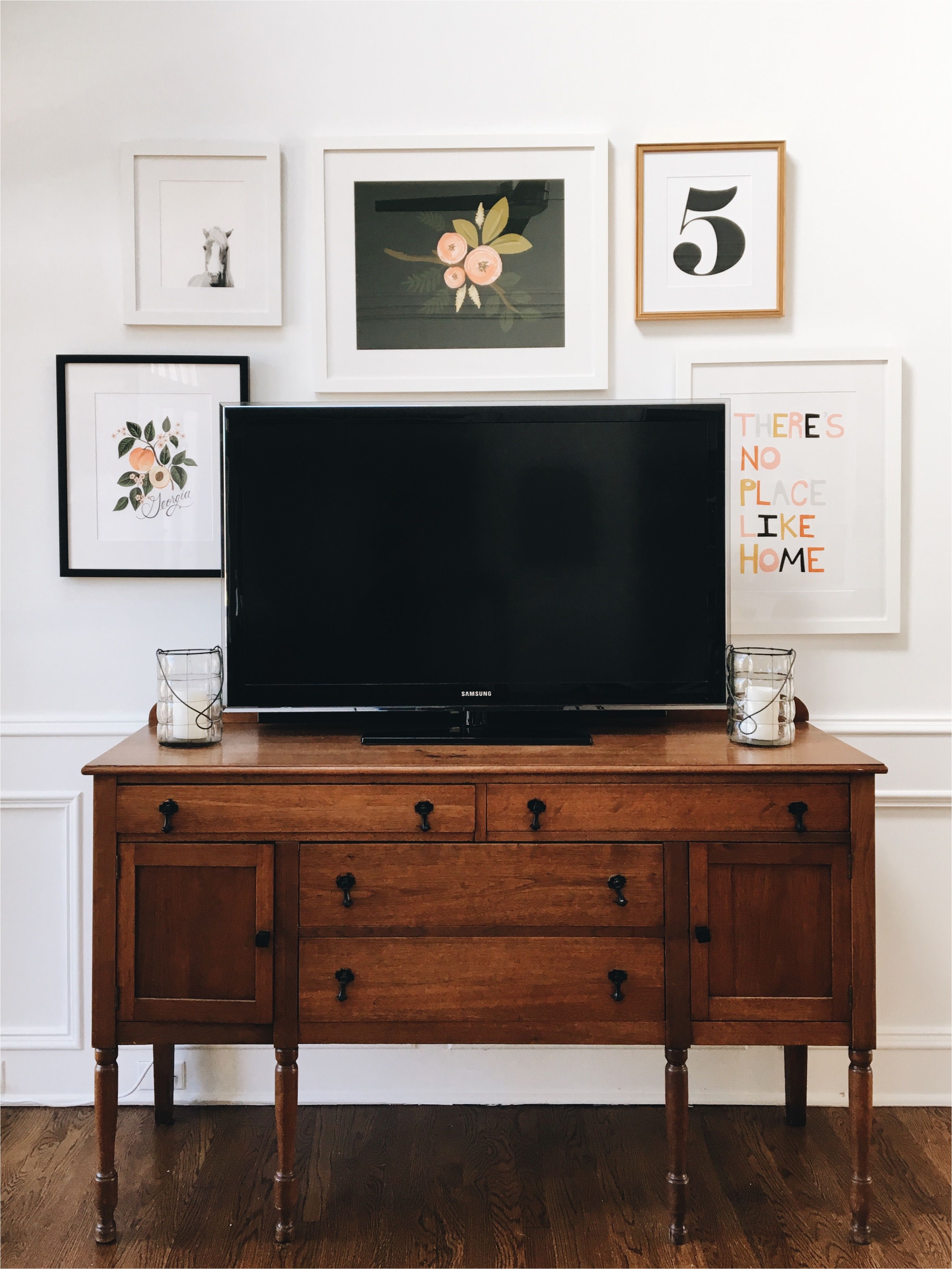 that wooden sideboard below the television gallery wall around the tv click through to see more of this lovely room