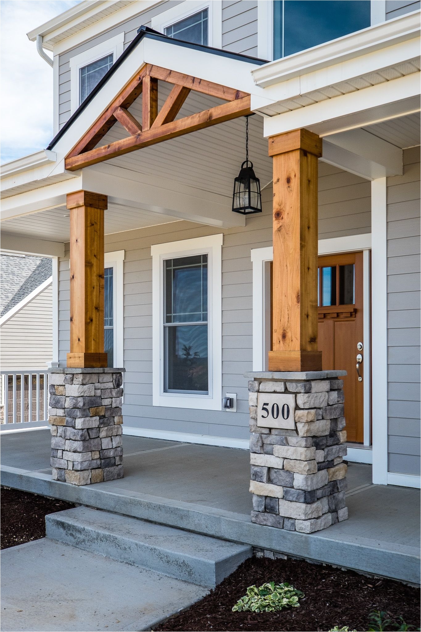 gorgeous front porch wood and stone columns