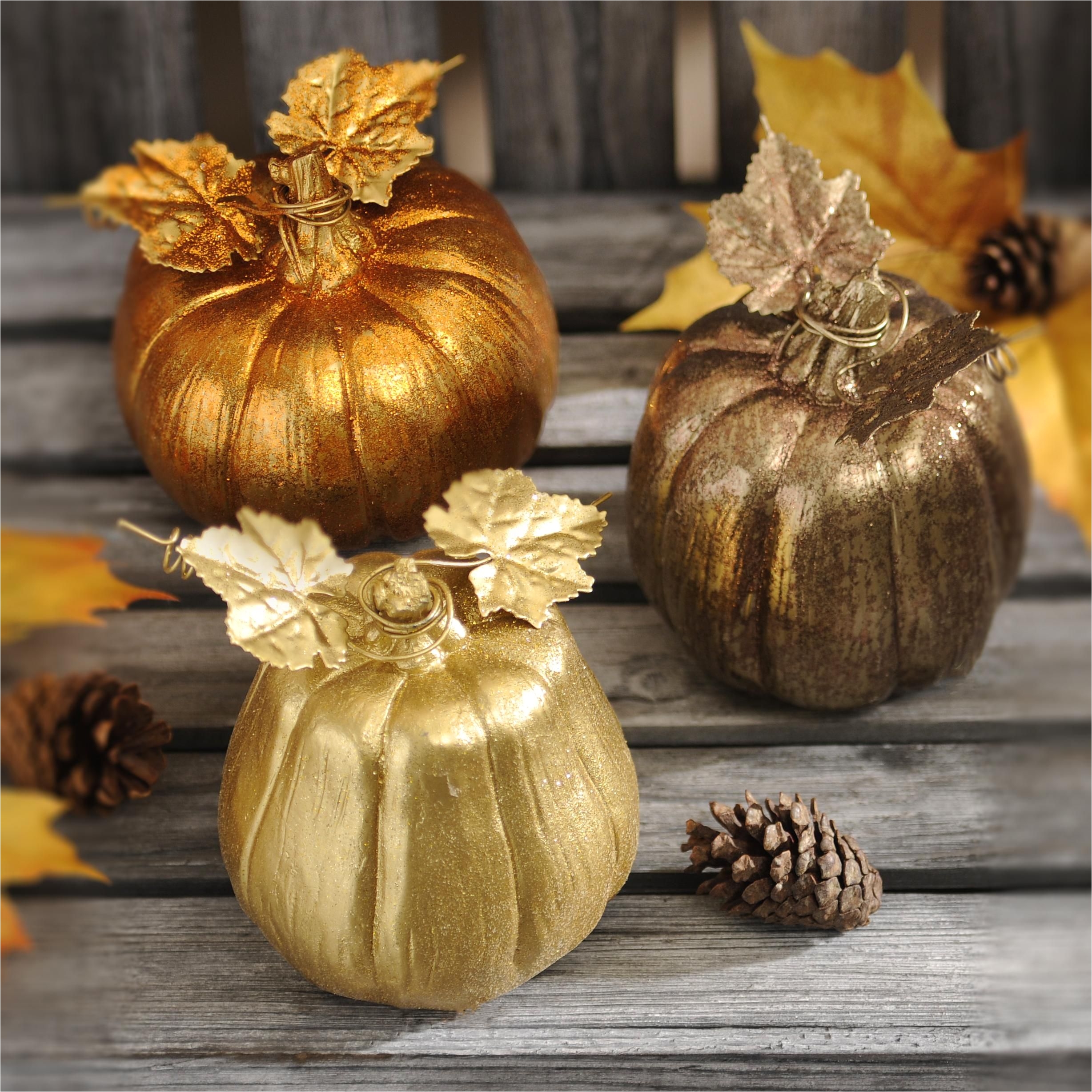 make your fall decor really shine with a set of metallic mini pumpkins these small decorations are glittering in gold orange and peweter and feature metal