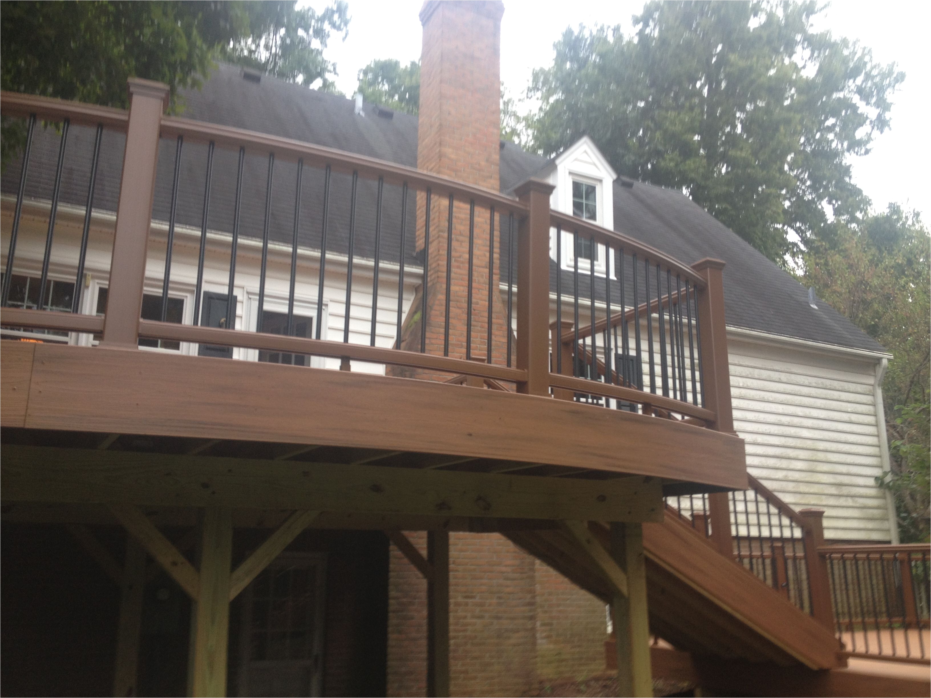 this is a large two level deck with curved decking and railing on both levels in