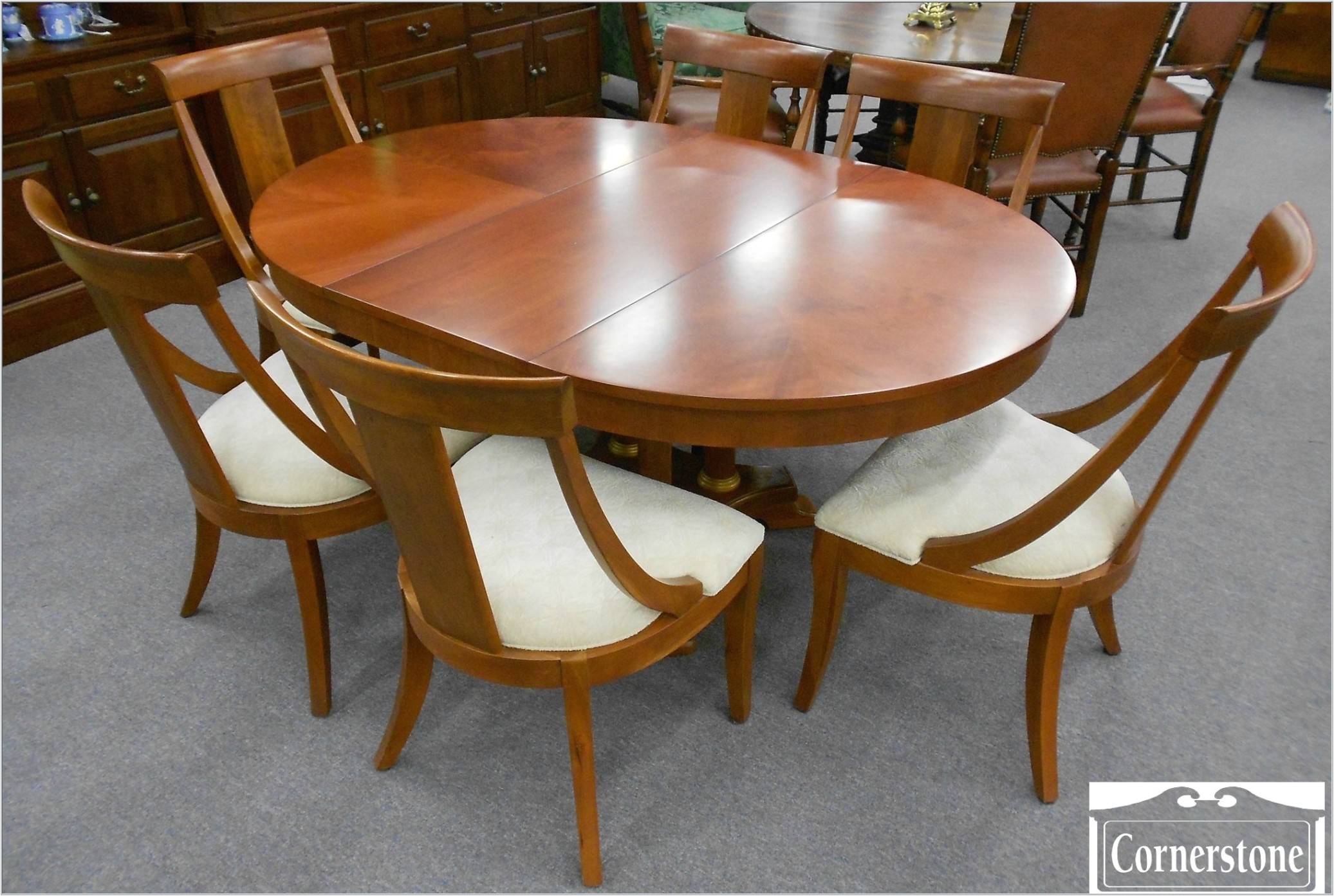 expandable oval brown wood ethan allen dining table with 6 dining chairs with white seat for