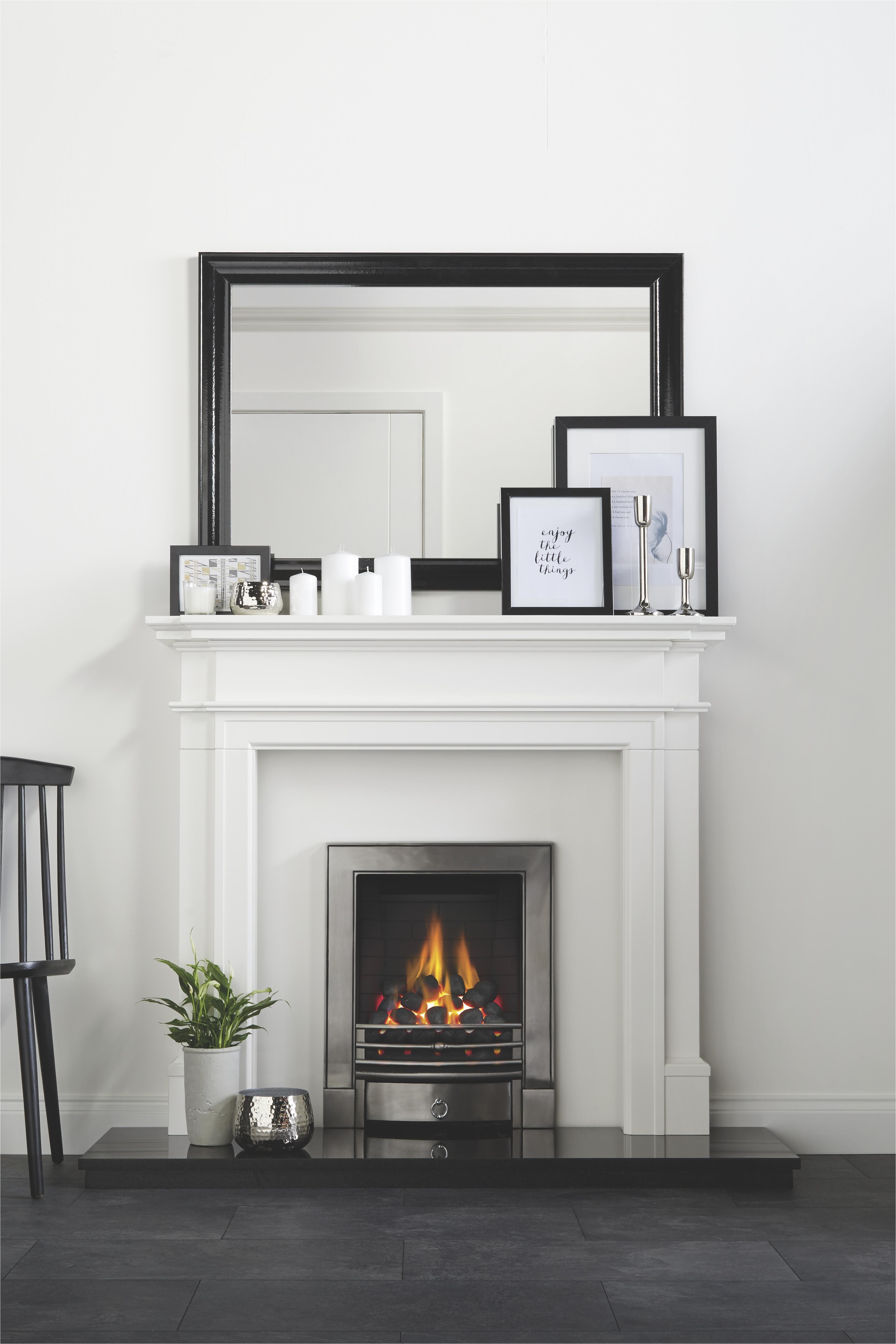 complement monochrome living with a sleek chrome electric fire and white surround