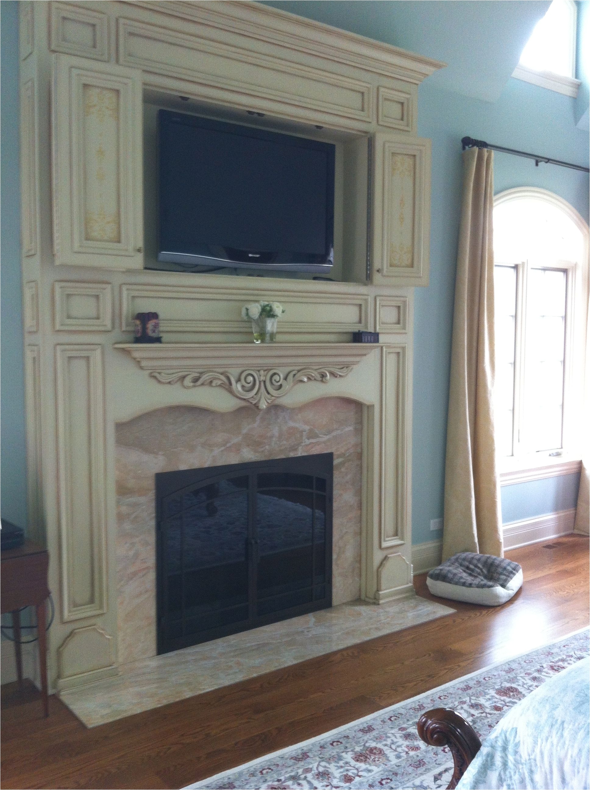 custom distressed white fireplace surround marble inlay around fireplace tv above fireplace tv cabinet above fireplace wood burning traditional fireplace