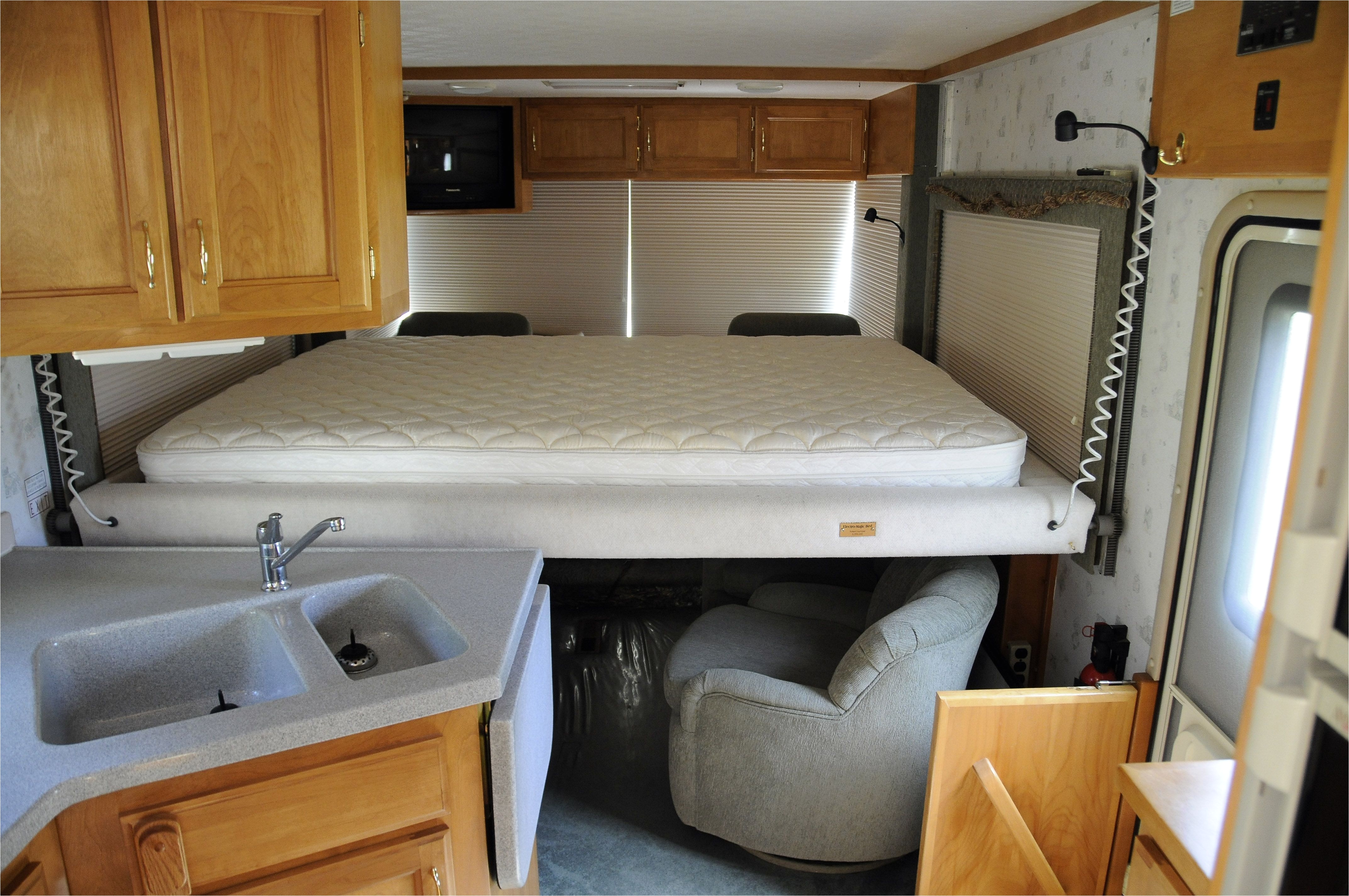 camper interior layout 1999 safari trek rv interior with bed lowered you can also see the