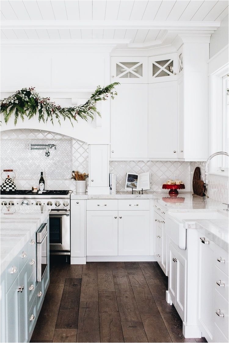 white kitchen classic white kitchen with arabesque backsplash tile marble countertop and hardwood floors white kitchen