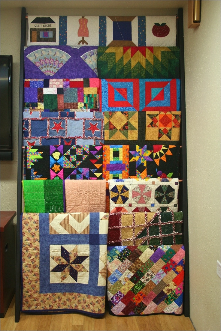 ladder quilt rack loaded with quilts
