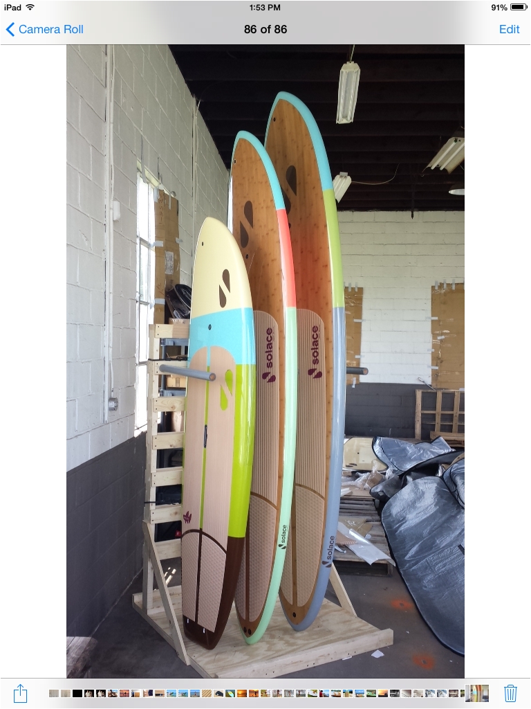 custom wood pallet paddle board rack completed for displaying our goodies a few of our solace sup models