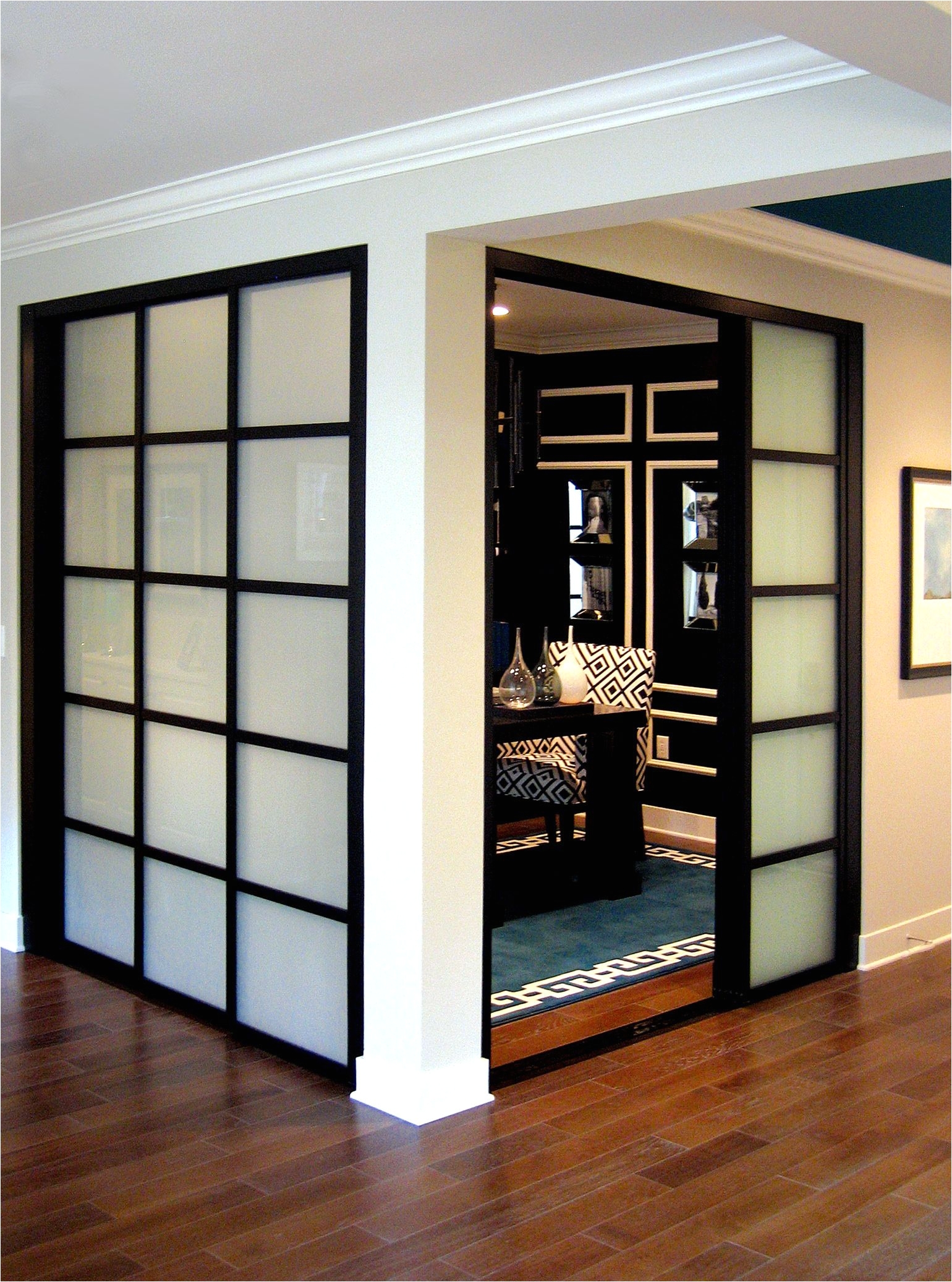 create room separation and an elegant dining space with sliding glass doors these frosted glass black frame finish pentagon frame design doors compliment