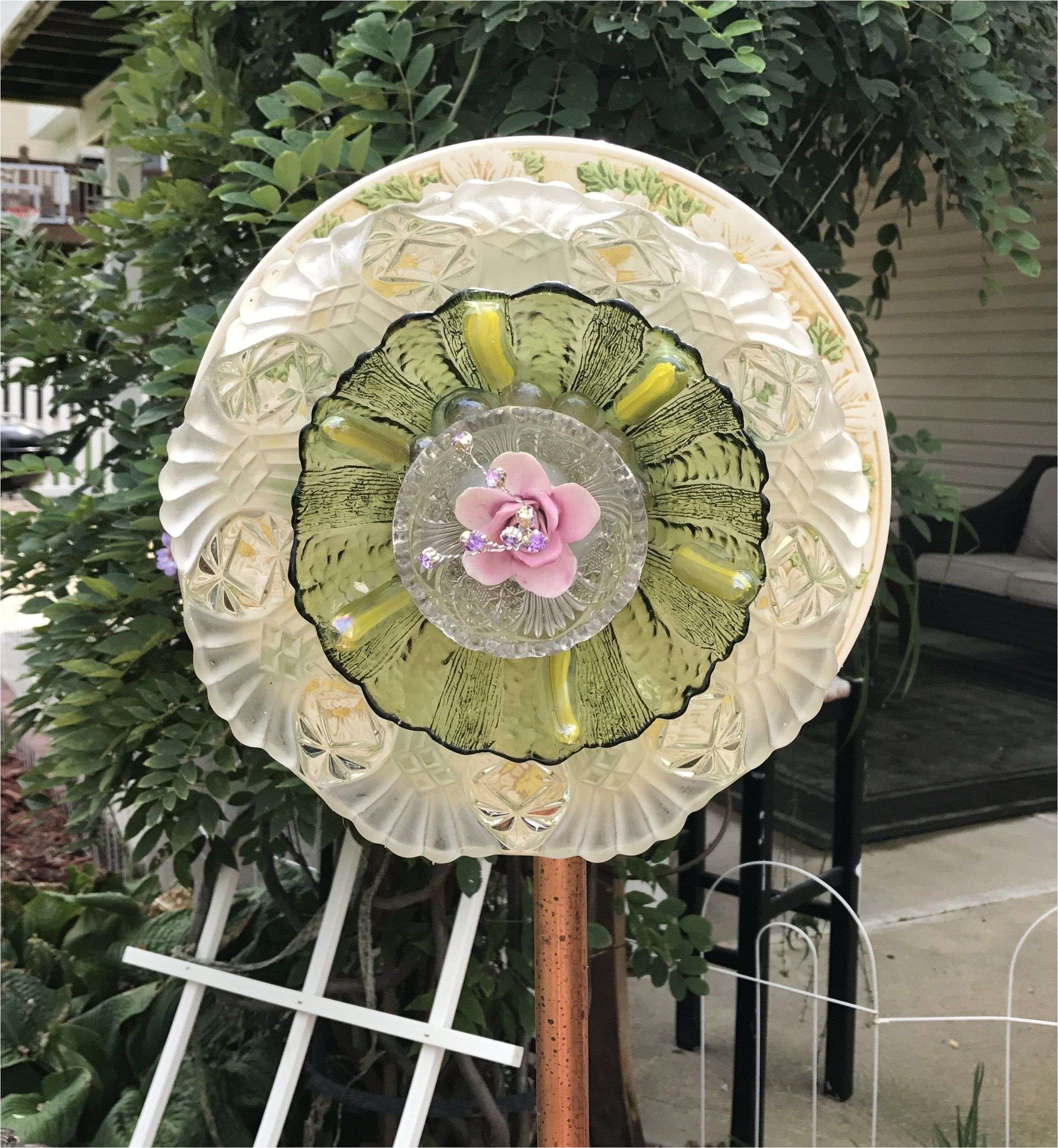 vintage repurposed glass and ceramic flower yard art with purple porcelain flower