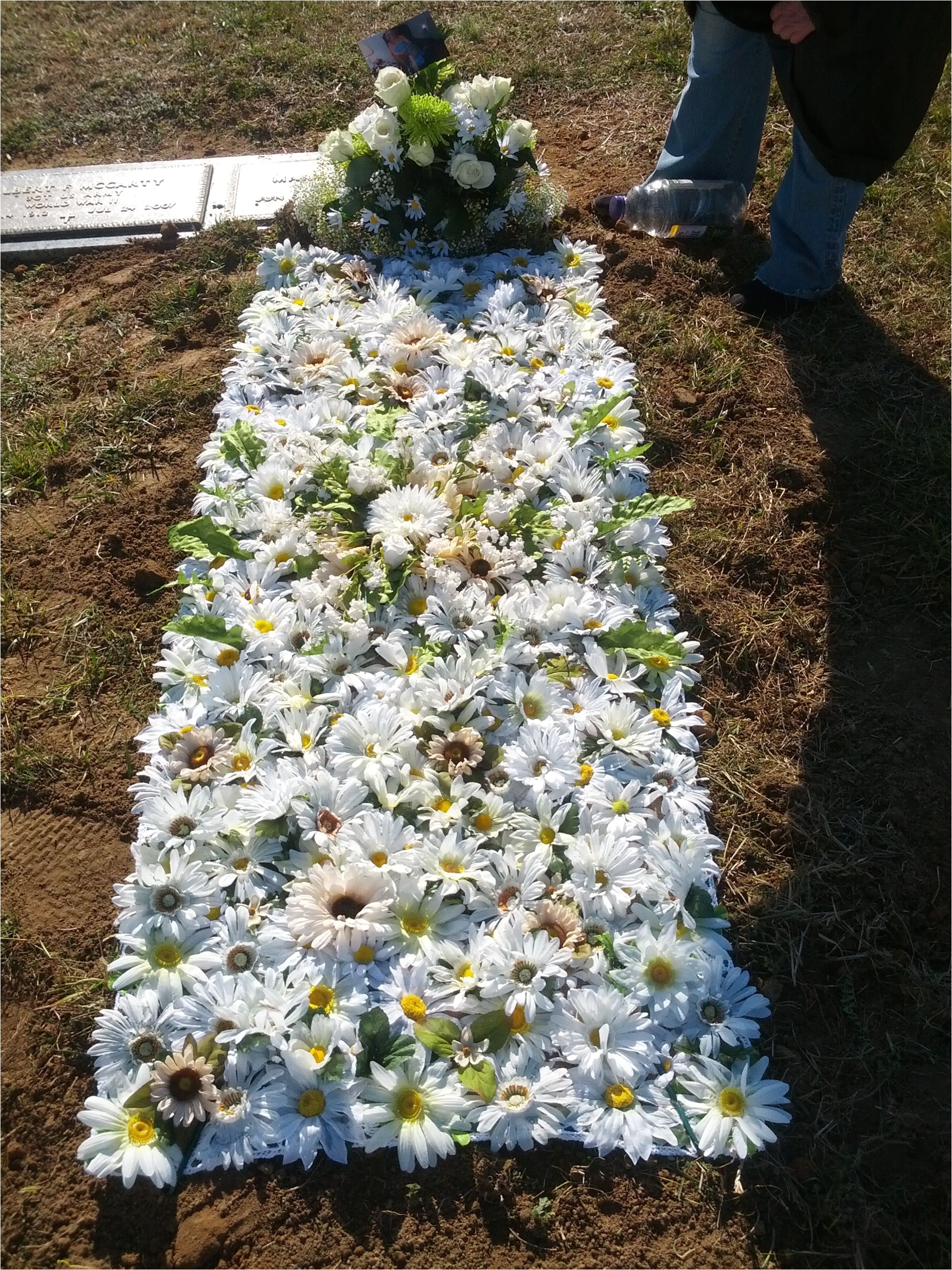 this is a blanket made from artificial flowers that my sister and i made for our mothers grave