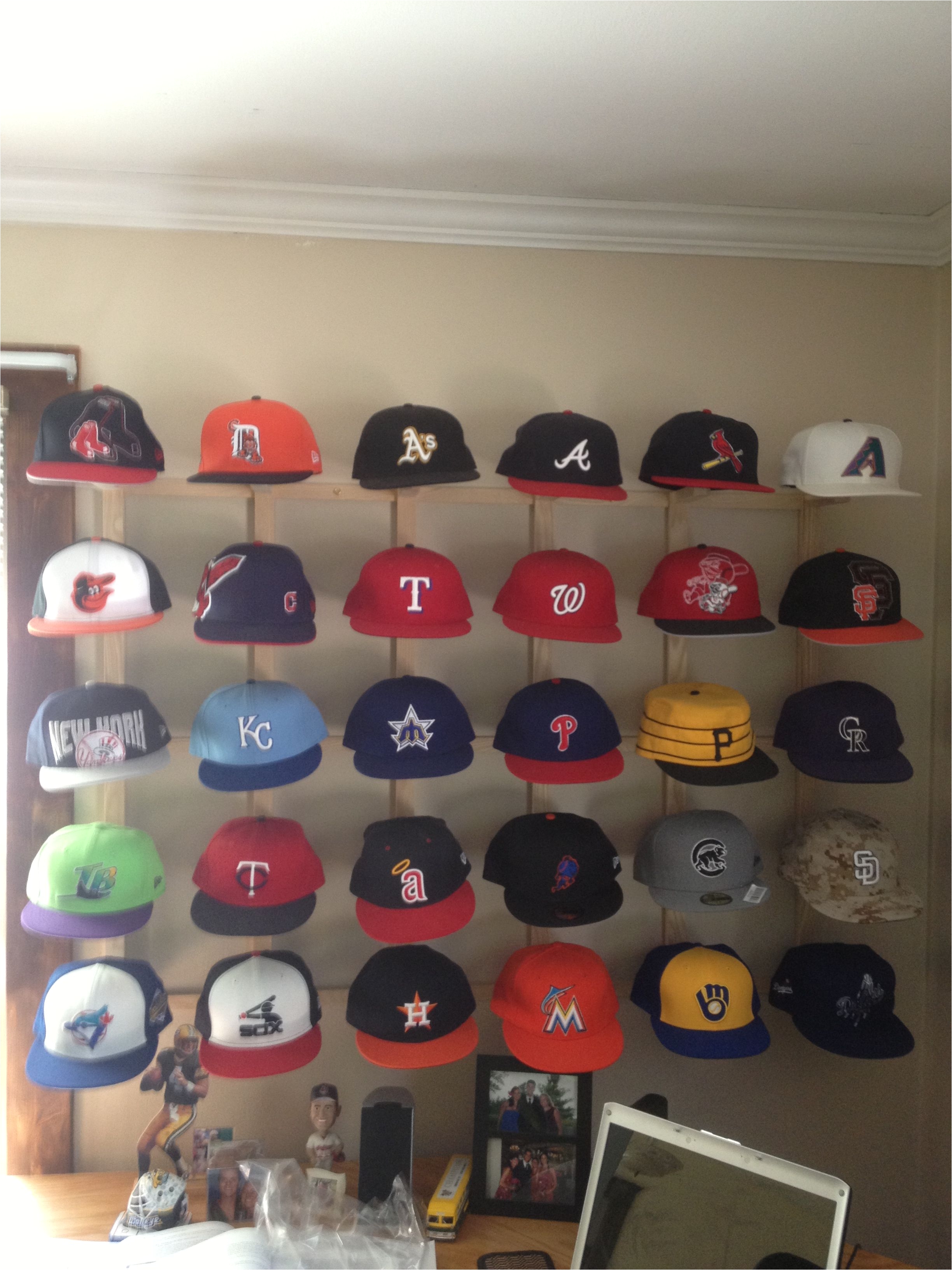 my hat collection is complete one hat from each team and a sweet way to display it i think my dad and i should patten this design