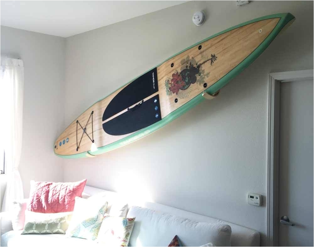 you can use the graphics on your paddle board as art work a storage solution where the adjacent wall keeps the board in place on the hawaiian gun rack