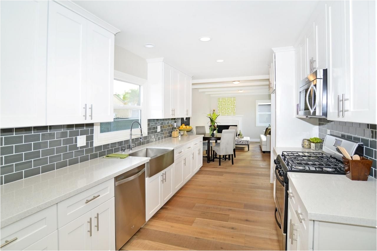 as seen on hgtv s flip or flop an extra long countertop is a creative way to make the most of the space in this bright white modern kitchen