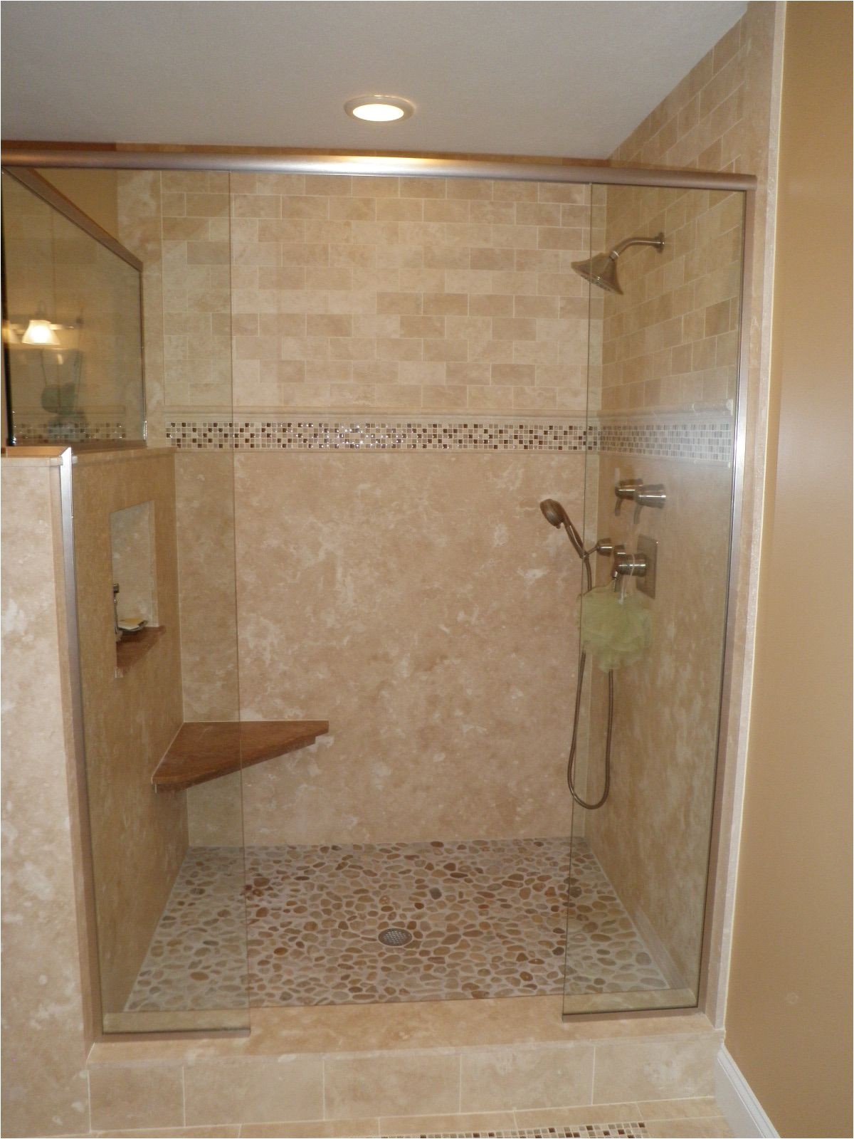 option solid surface on bottom travertine above custom tile shower love the pebble floor