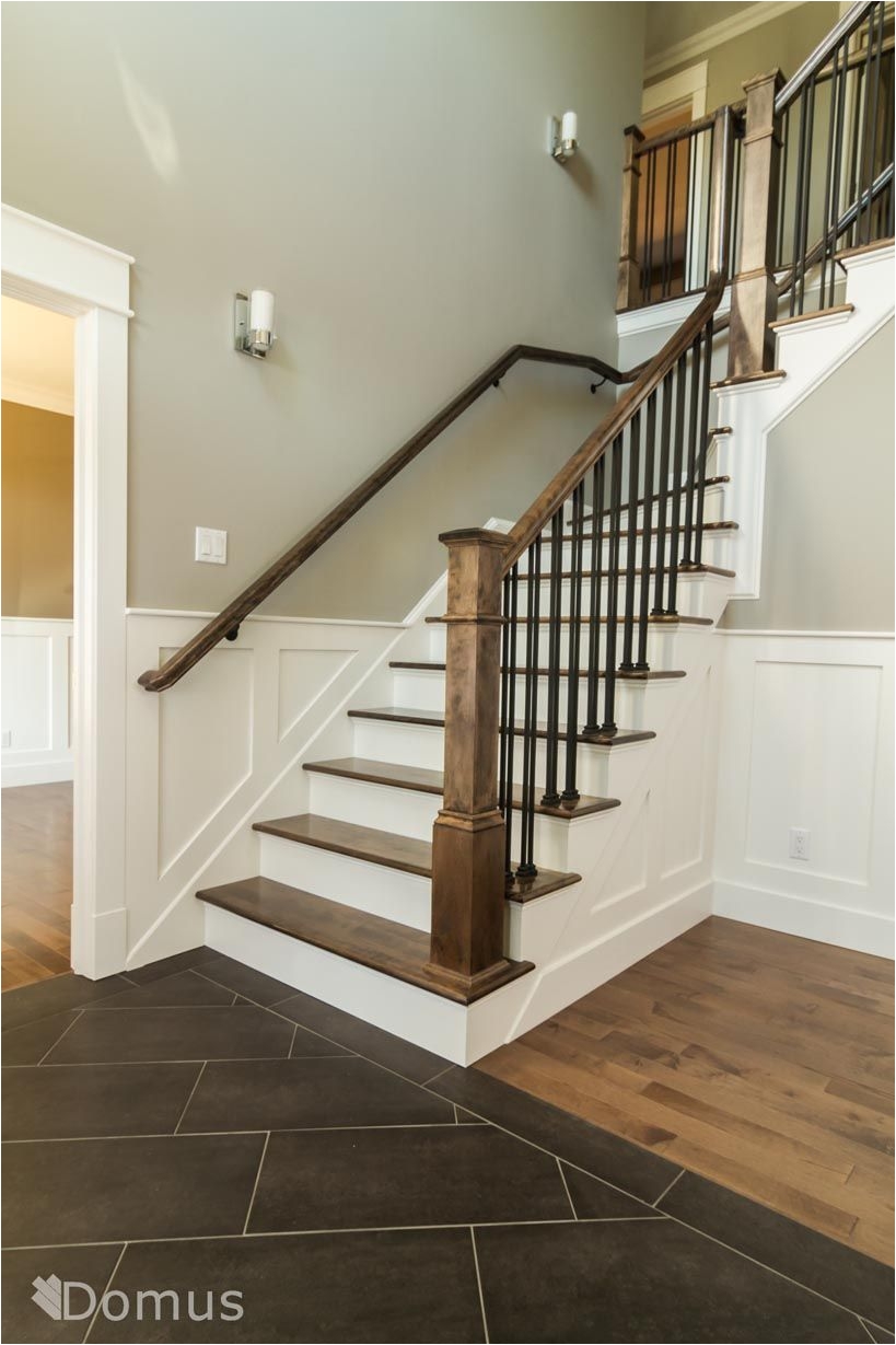 staircase with white accents and black metal spindles
