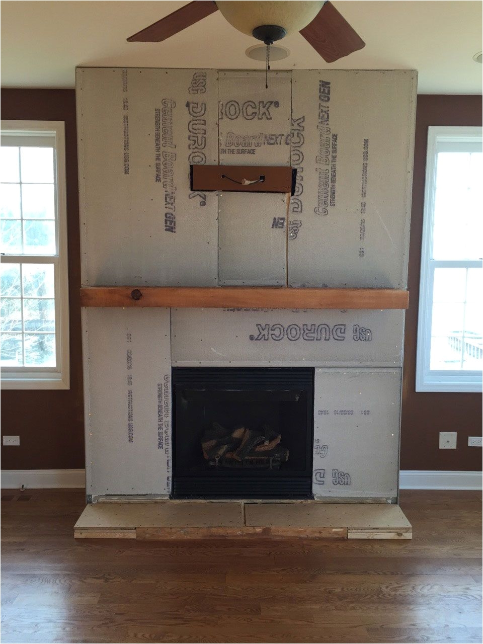 a step by step diy stone veneer installation on a fireplace in only 4 days