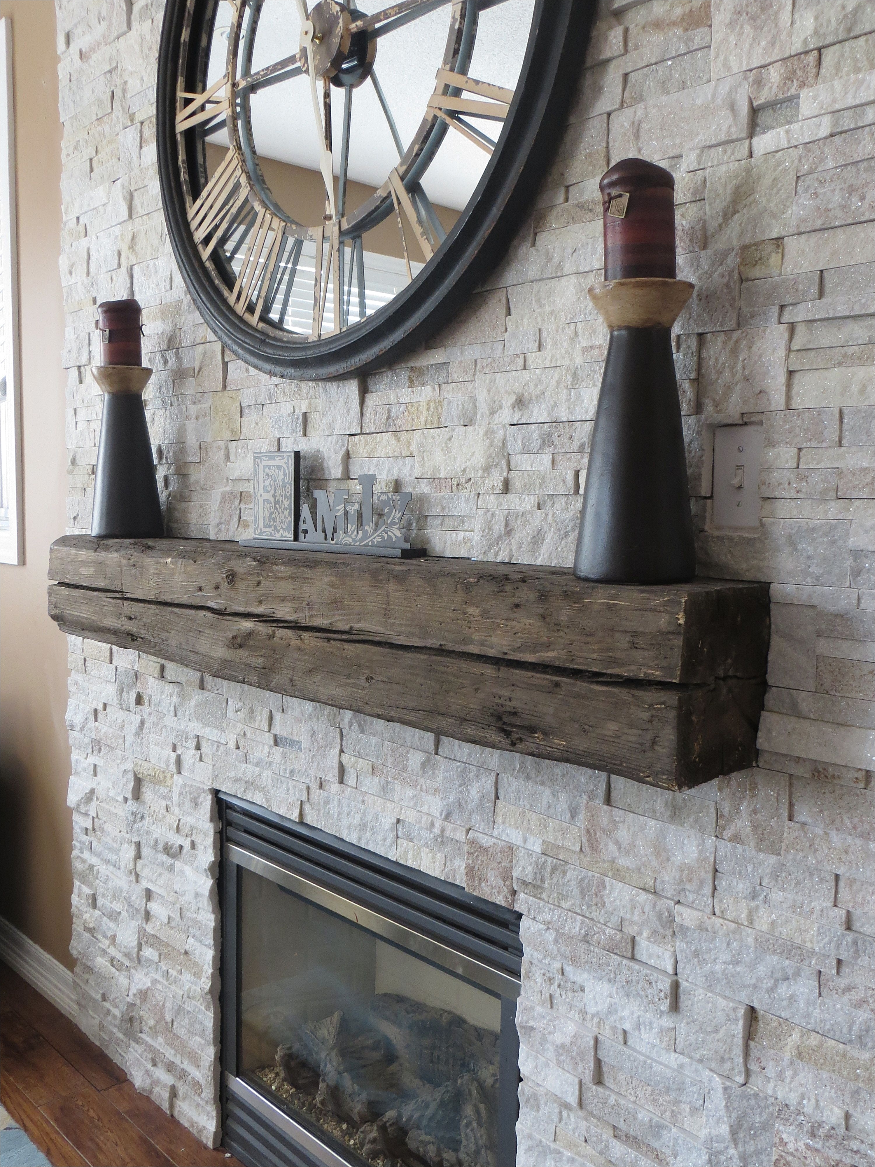 beautiful stone veneer surround for gas fireplace with rustic wood mantel detail by m v contractors