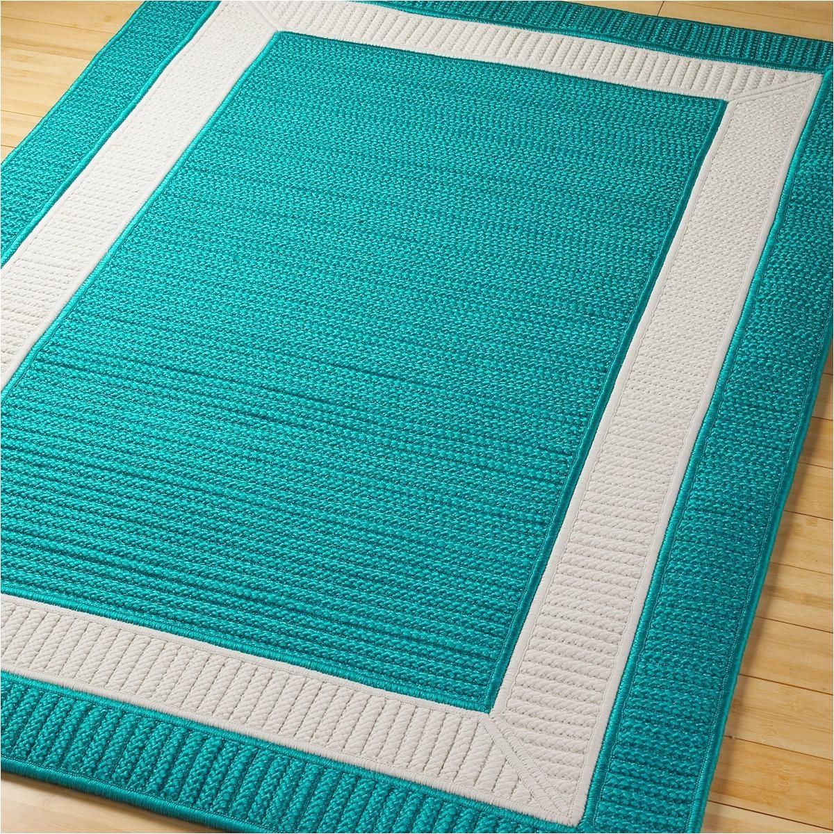 border braided indoor outdoor rug in turquoise