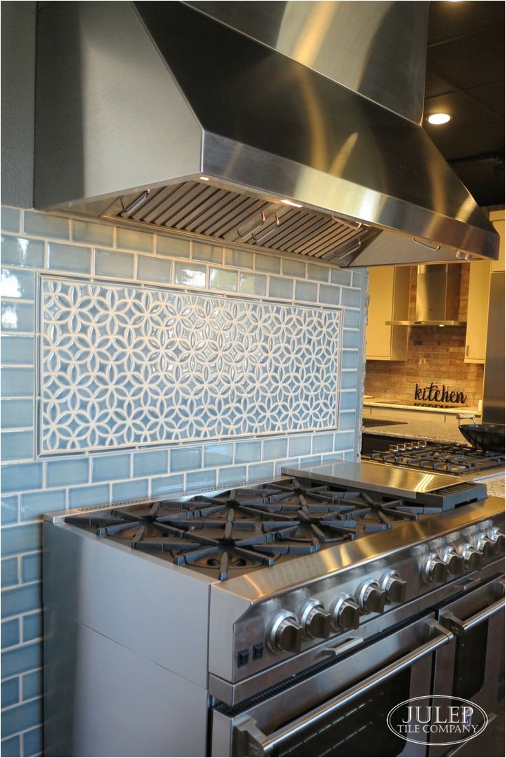 adding a decorative accent over the range is a great way to bring pattern into your