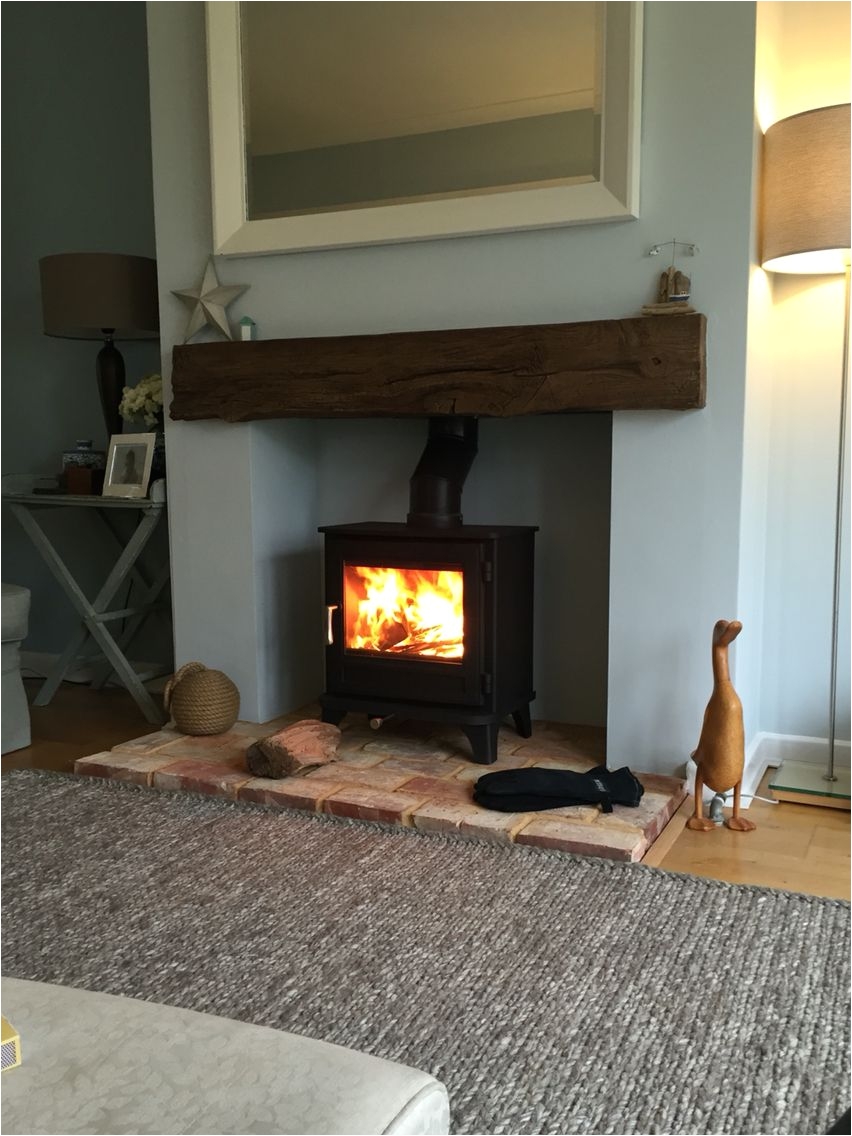 chesney log burner timber effect beam grey rug reclaimed brick hearth