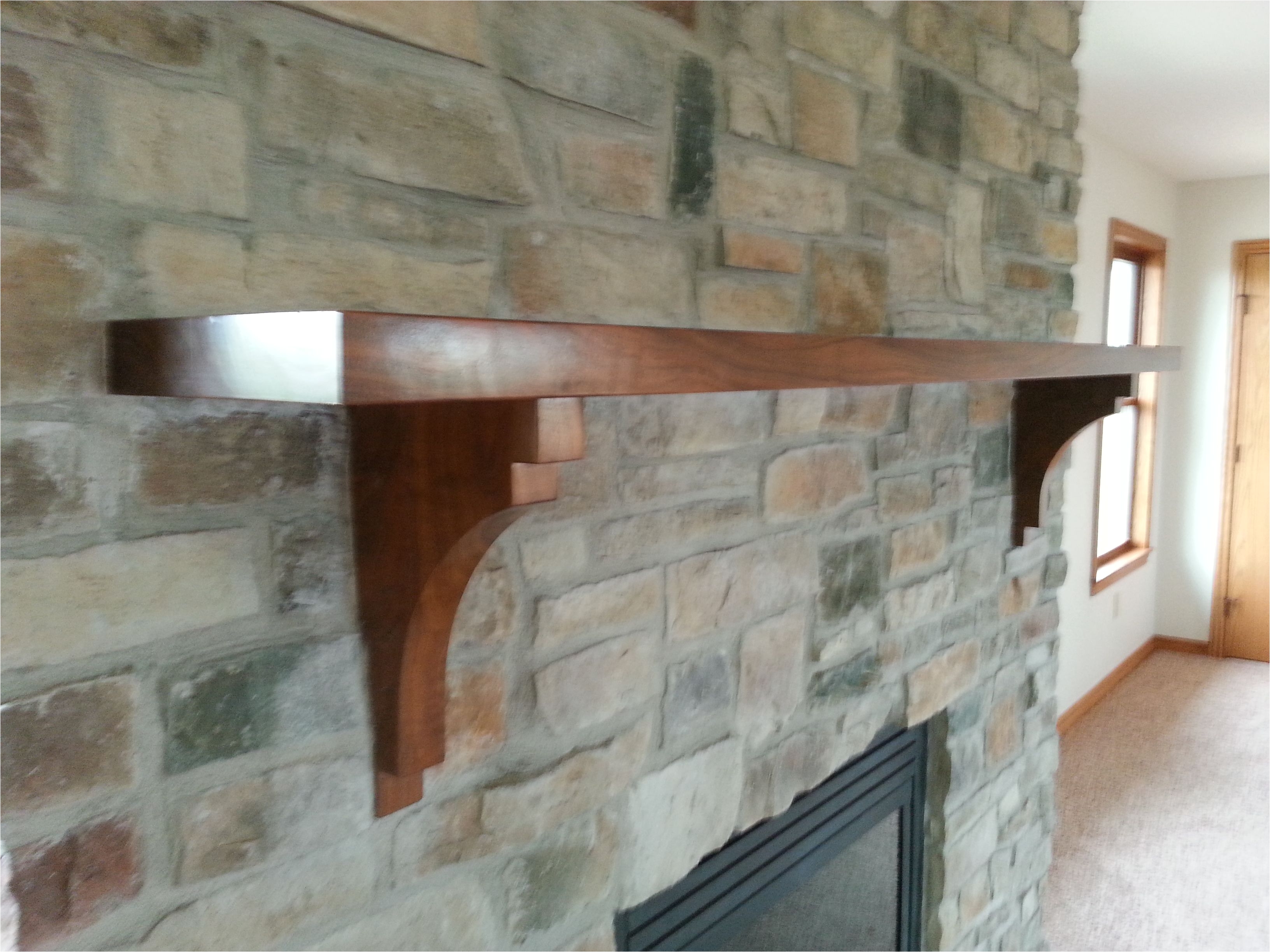stone fireplace with refurbished mantle
