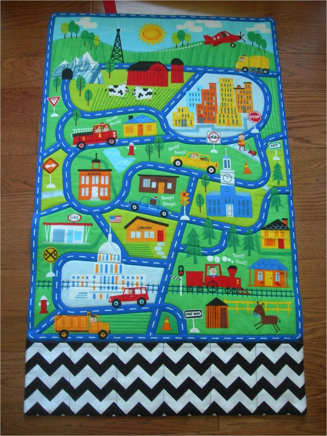 this large quilted play mat of a town scene will provide hours of fun for any special little boy or girl this car play mat with roads and