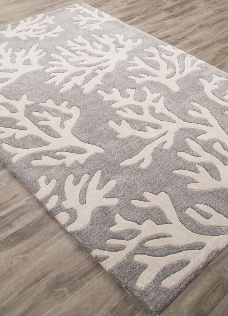 the coral branch pattern is created with carved details on this plush hand tufted polyester rug
