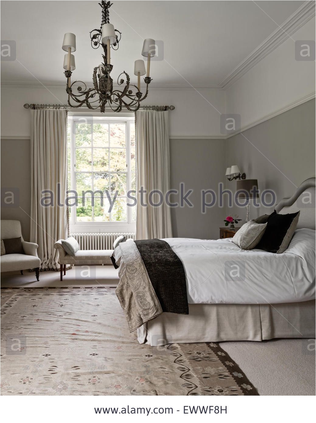 elegant bedroom painted in pale walnut by dulux with an aubusson rug the curtains are in abbot and boyd s lins brodes stock photo