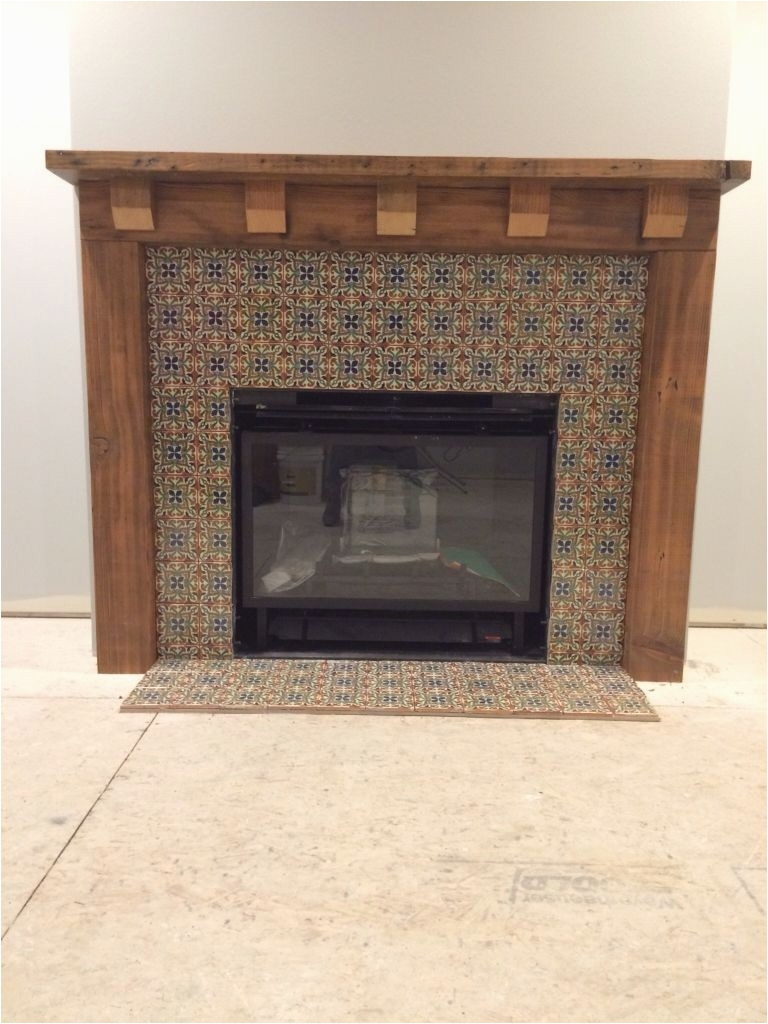 fireplace mantle of reclaimed fir and mexican tile