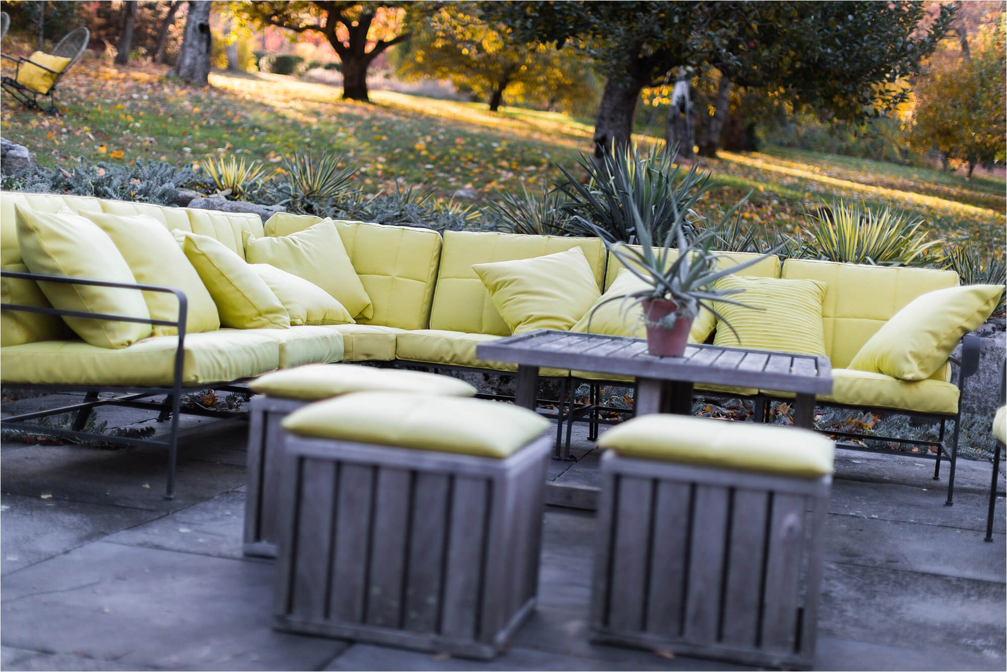 sofa on outdoor patio featuring cushions with green sunbrella fabric