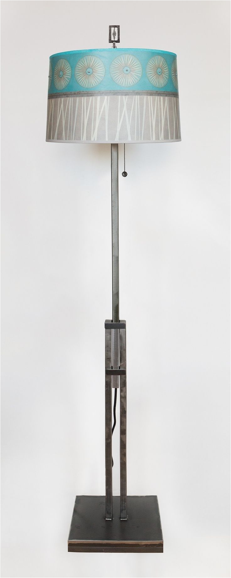adjustable height steel floor lamp with large drum shade in pool