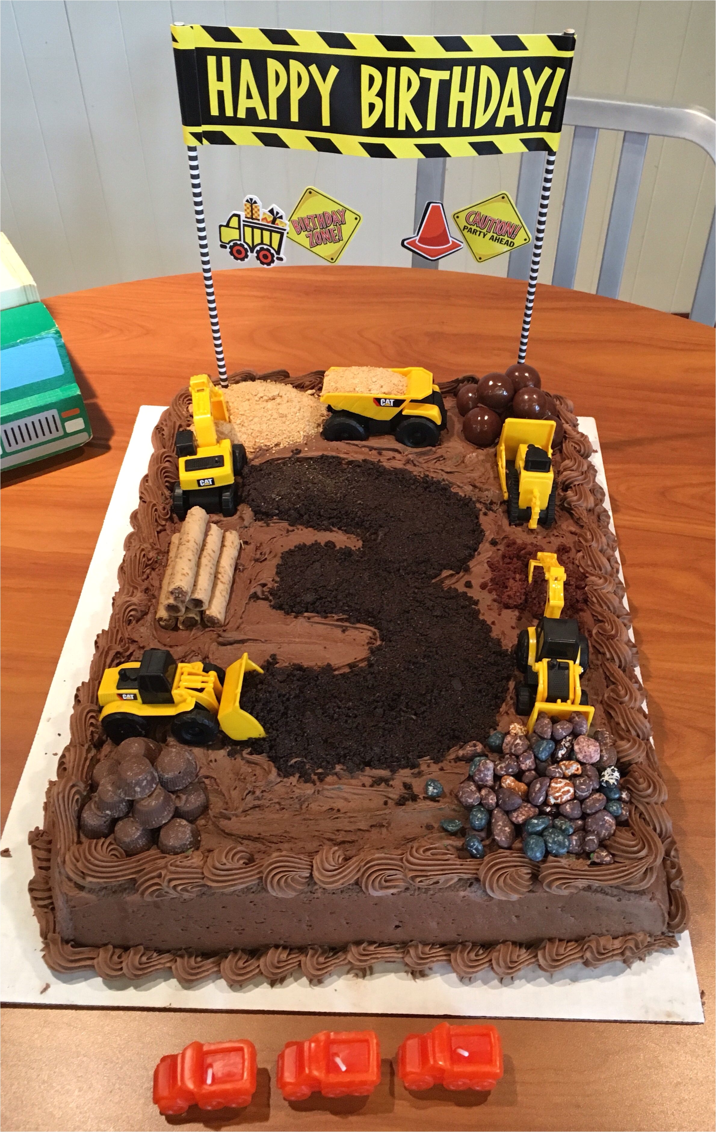 carter s construction cake got a sheet cake from costco chocolate candies from winco s bulk bins the 3 is crushed oreo the sand is graham cracker