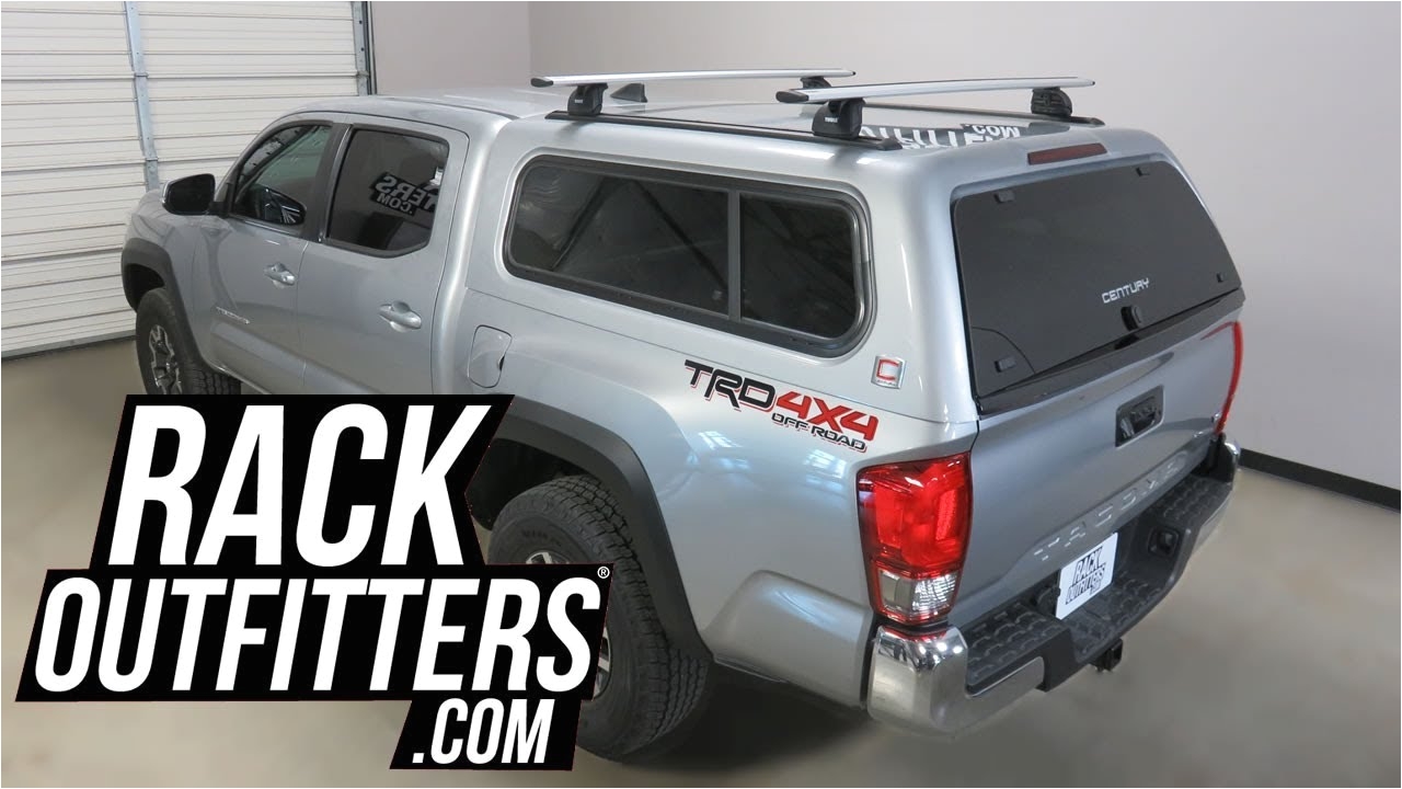 toyota tacoma with century truck cap with thule rapid podium aeroblade roof rack crossbars