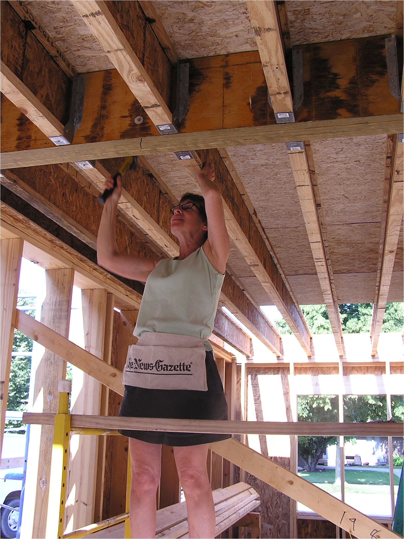 a family friend marcia hammers in joist hanger nails