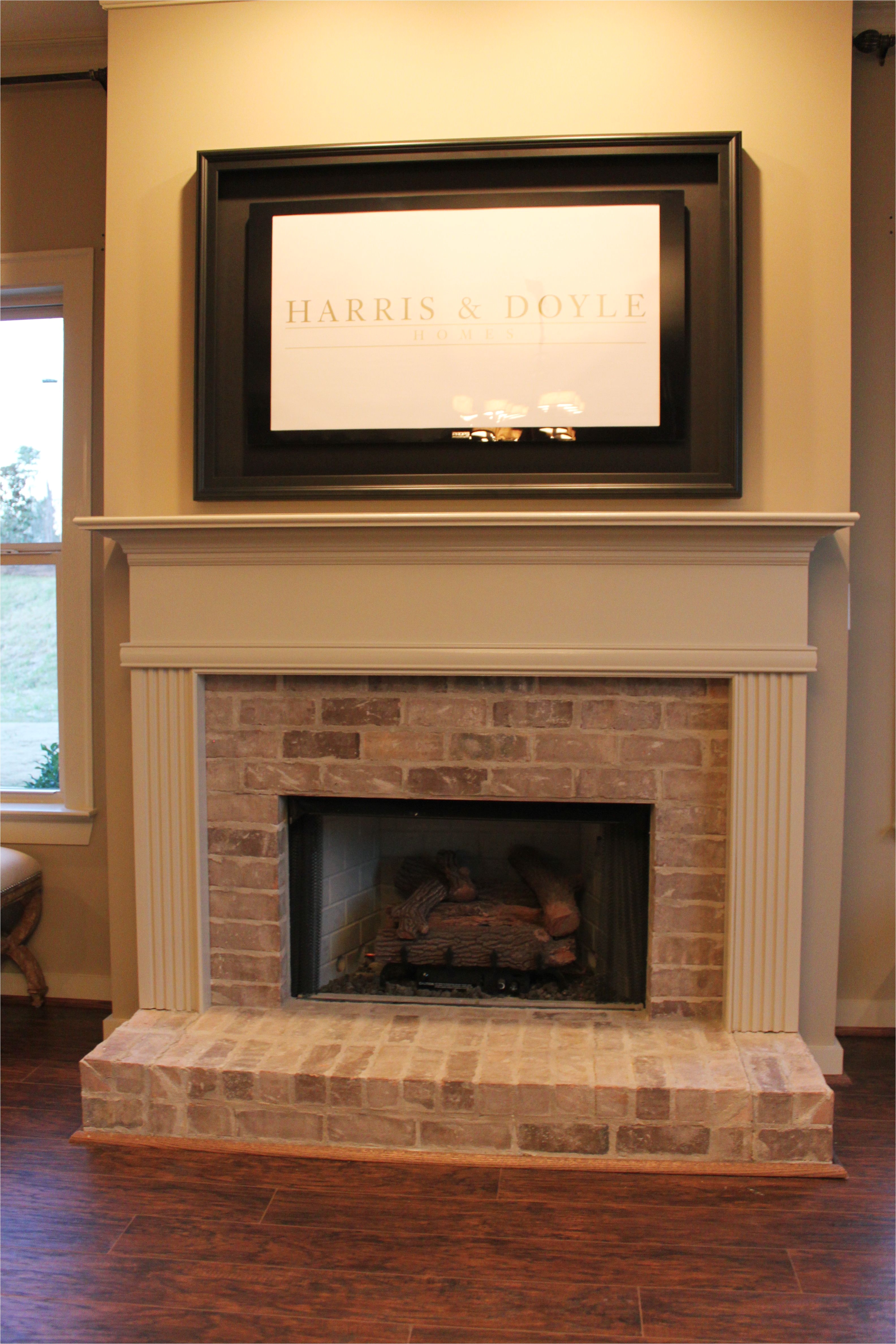 half brick fireplace surround with elevated hearth