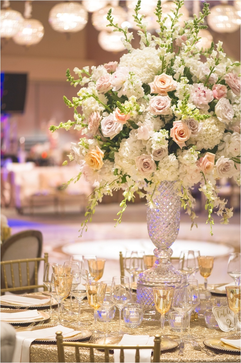 wedding reception table with cut crystal vase full of white hydrangeas orchids pink