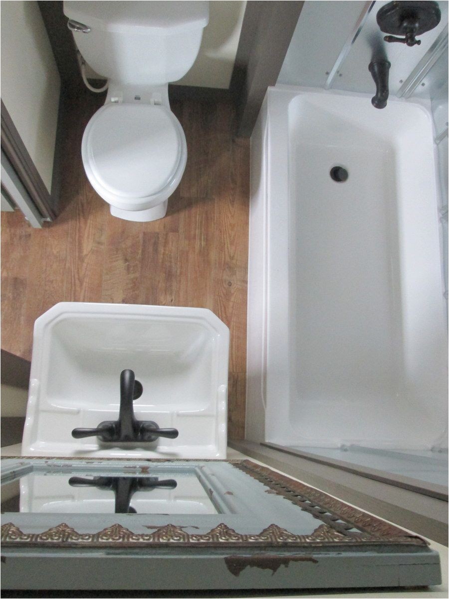 small compact bathroom very efficient layout like the stainless steel tub surround really like this a little better than the wavy or corrugated sheets