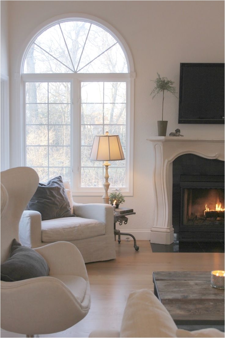 belgian style in my living room with french fireplace arched windows and white oak